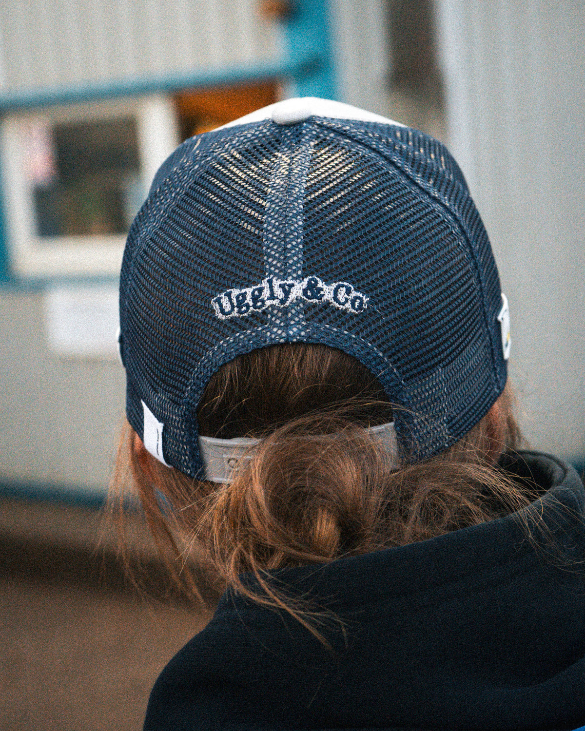 Katie Hand wearing the Uggly&Co Off White and Navy Diamond Trucker Hat
