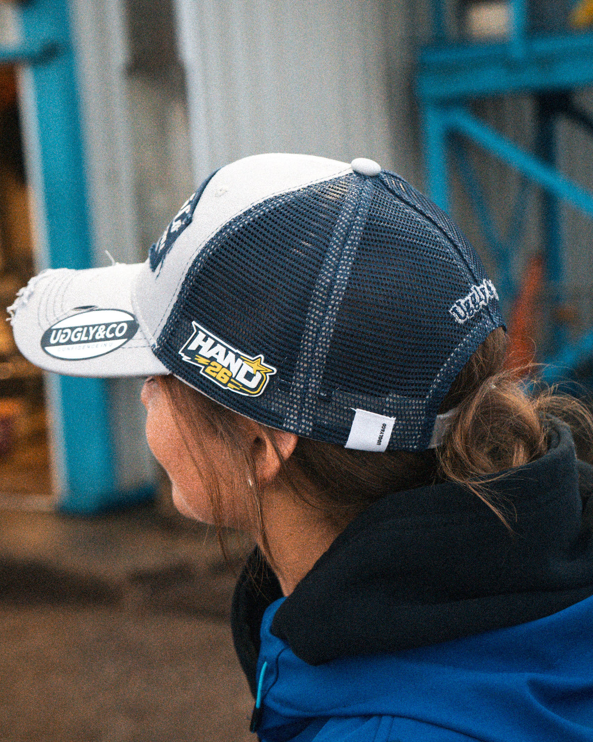 Katie Hand wearing her Uggly&Co Off White and Navy Diamond Trucker Hat