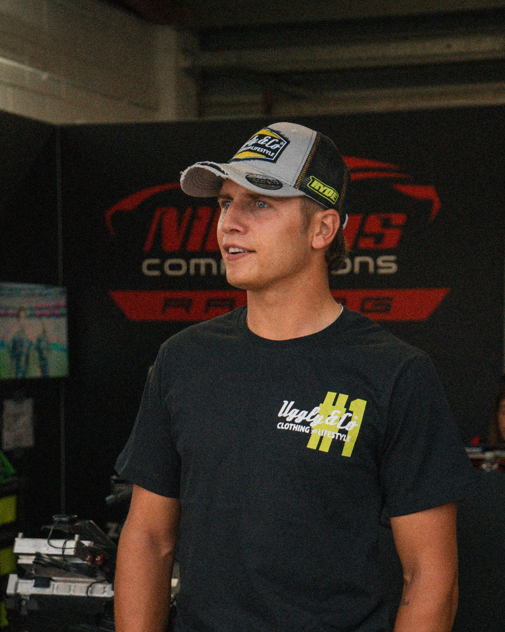 Kyle Ryde Stone Grey Trucker Hat styled in a motorsport lifestyle setting