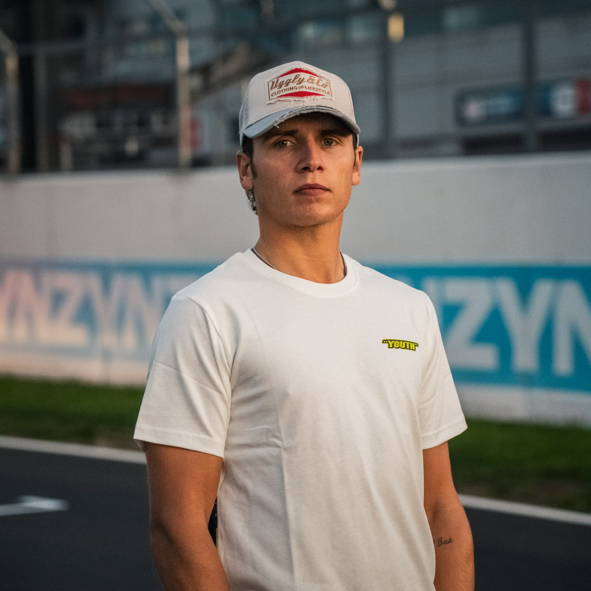 Kyle Ryde White Graphic T-Shirt photographed trackside at Donington Park, showcasing Uggly & Co motorcycle lifestyle clothing.