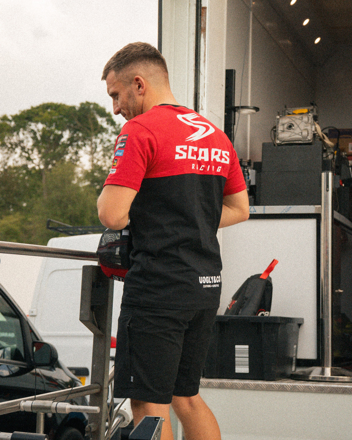 Luke Stapleford wearing the Scars Racing team T-shirt at a motorsport event