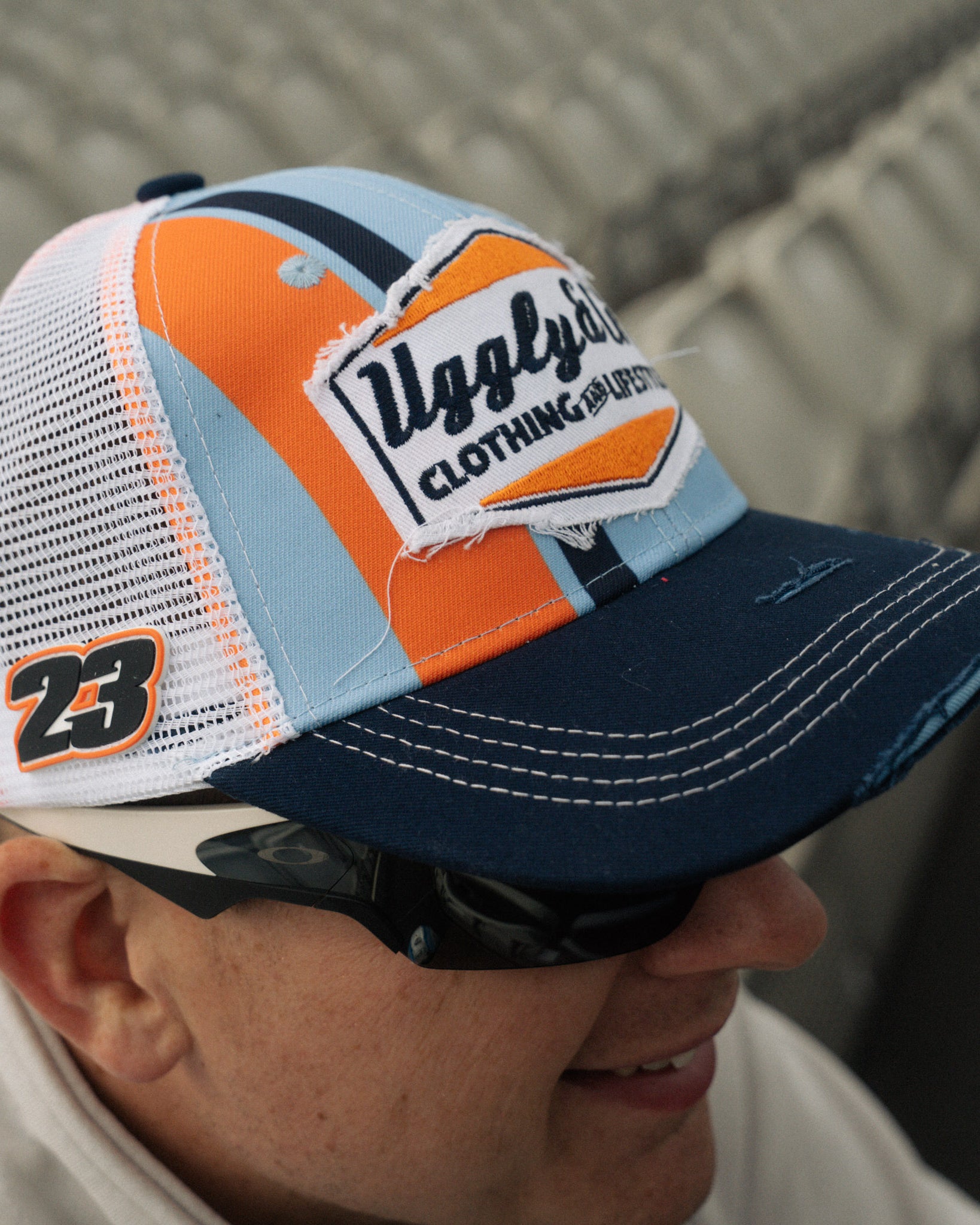Marcus simpson in racing seats wearing gulf colors cap