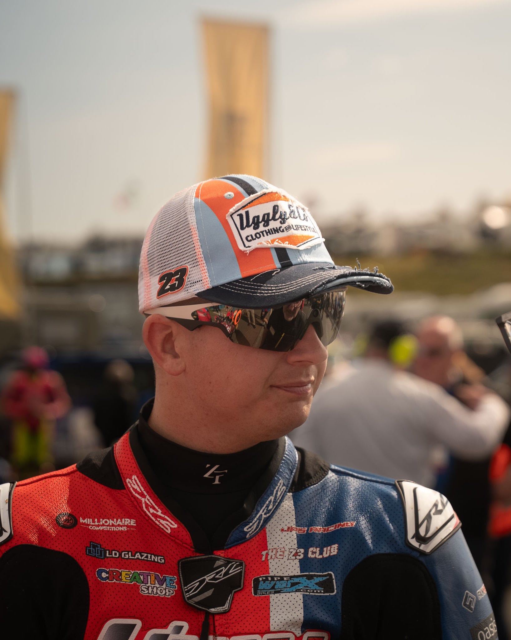 Marcus Simpson signature snapback hat with blue and orange colorway, retro hat seen in pit lane