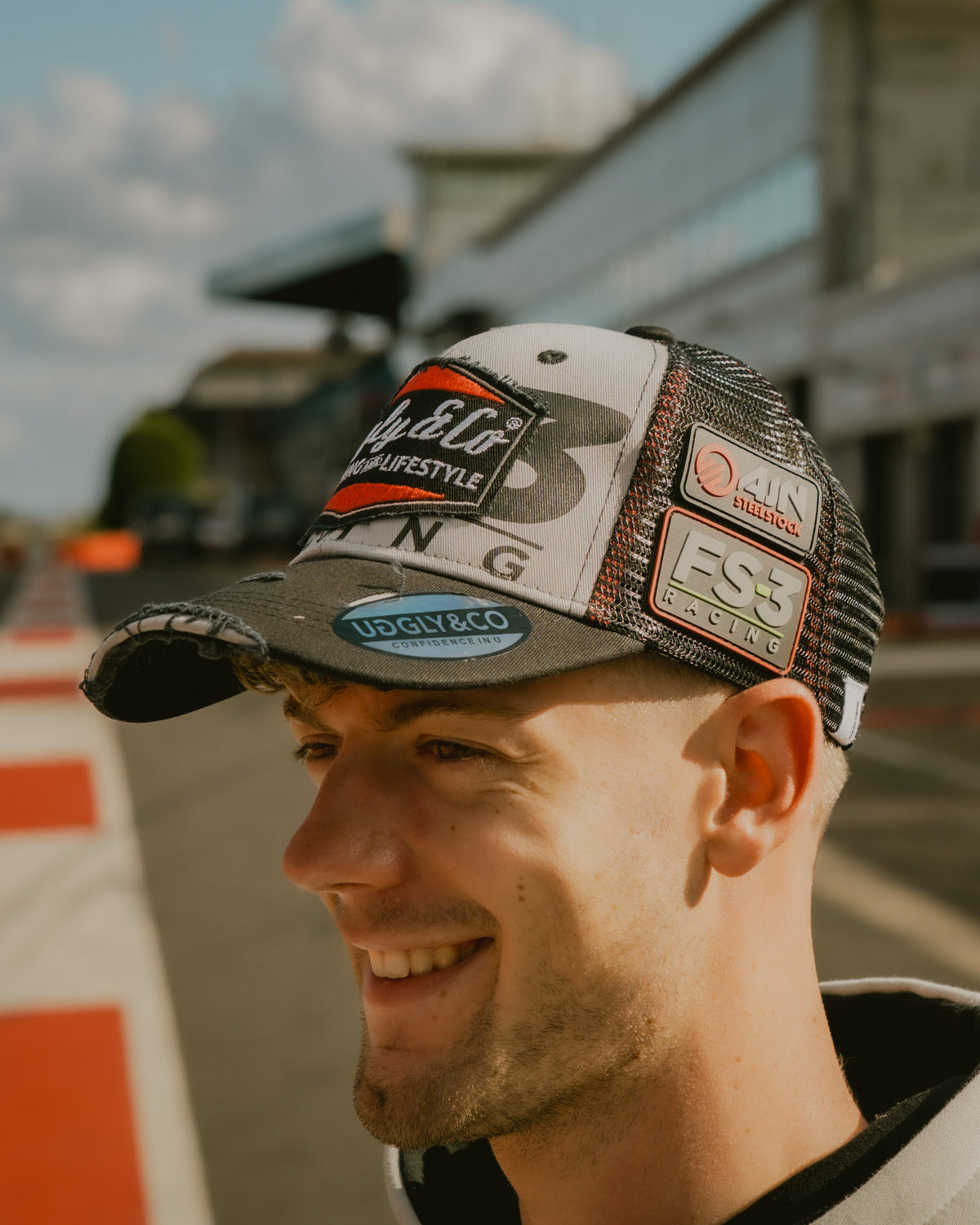 Side view of Max Cook wearing the FS-3 Superbike Racing Trucker Hat in the pit lane