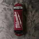 Skateboard deck with Milwaukee logo on a textured surface