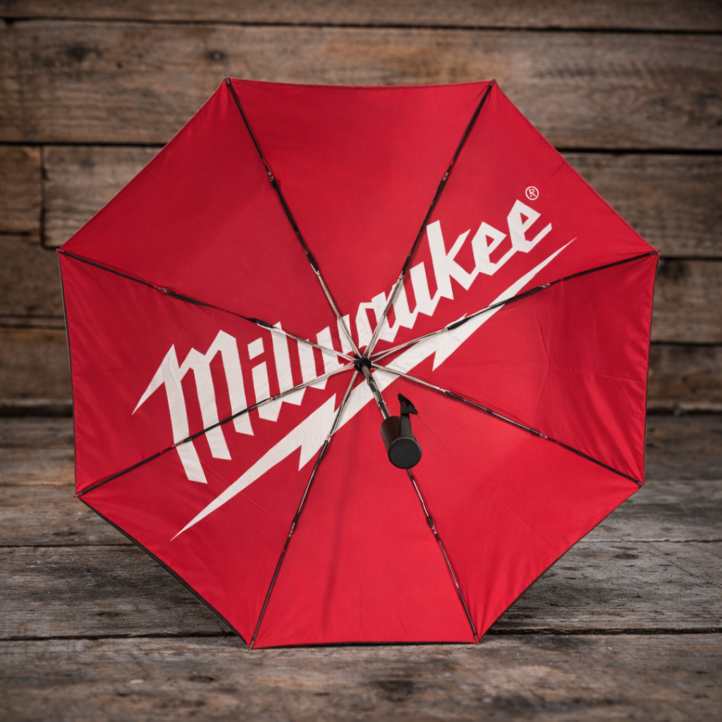 Inside view of a red and black Milwaukee x Ducati umbrella with Milwaukee logo on a wooden background
