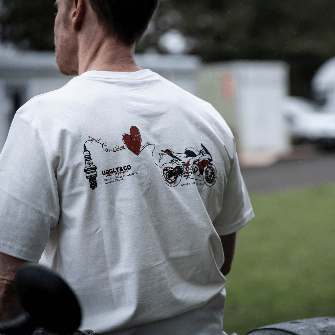 Rear view of a model wearing a limited edition Valentine’s white t-shirt with spark plug heart graphic, and Uggly&Co logo
