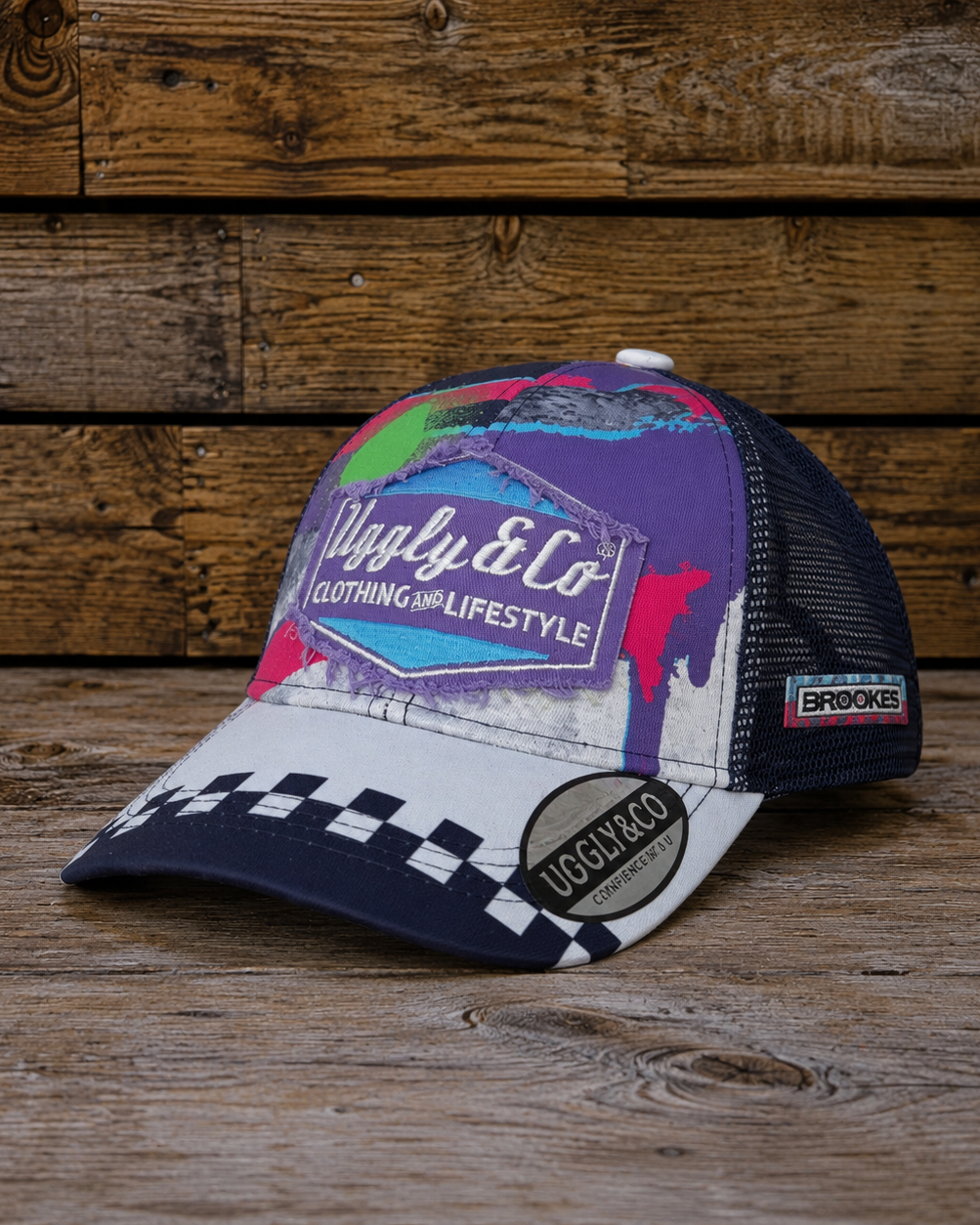 Josh Brooks x 80s Vintage Motocross Diamond Cap with purple, white and checkered racing design on a rustic wooden background.