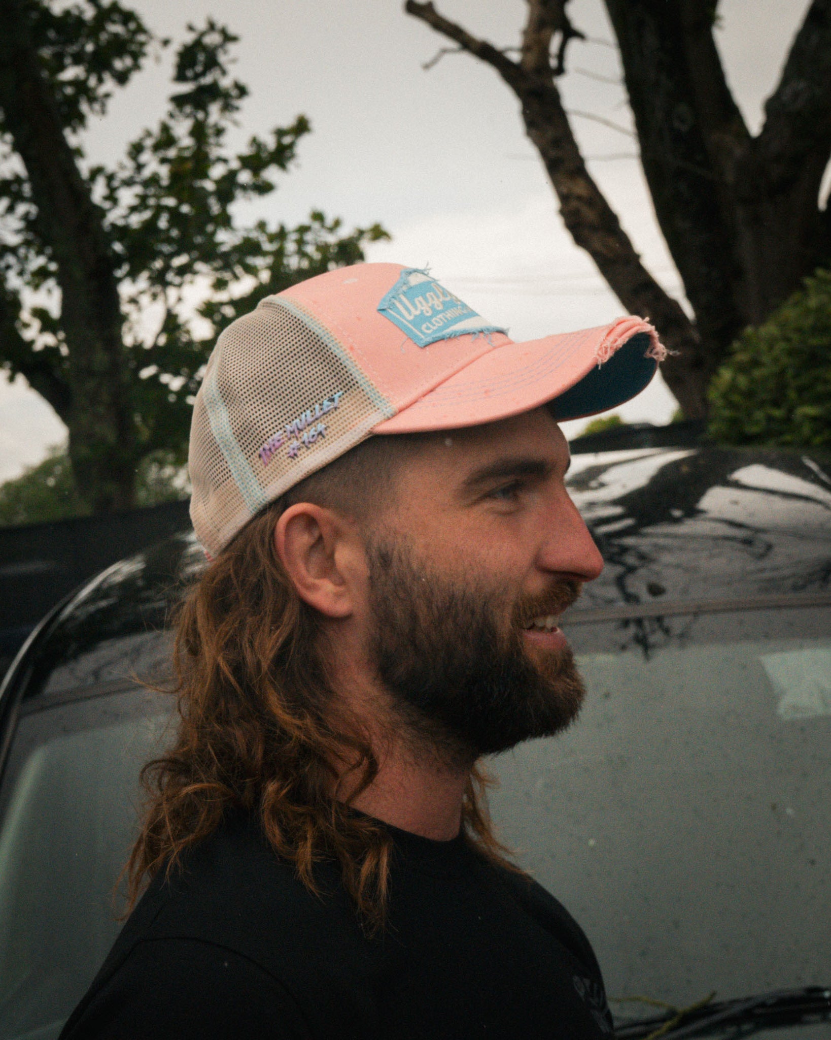 Close-up of Matt Stevenson wearing the pastel pink and blue cap