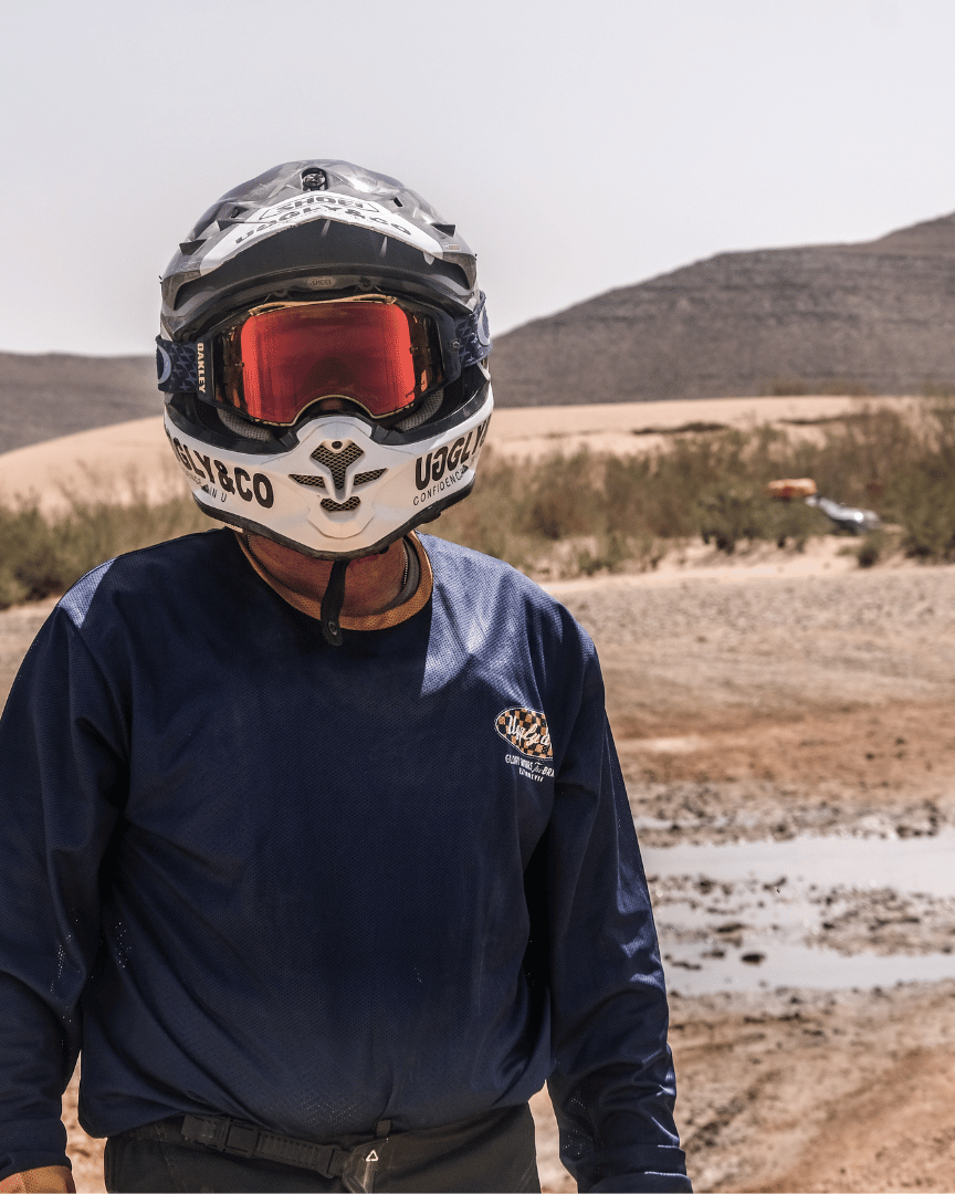 MX rider in the desert in a blue Uggly&Co motocross jersey