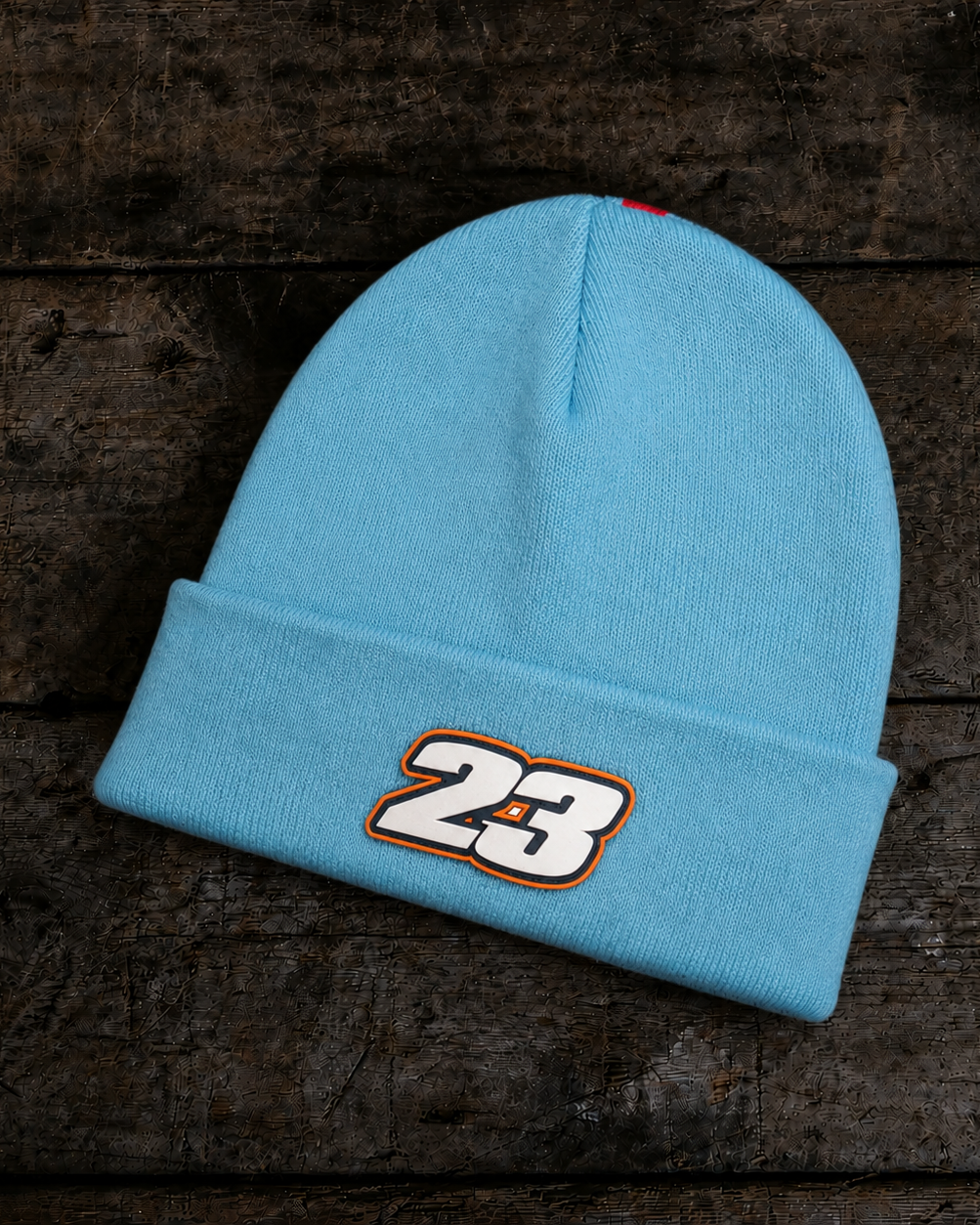 Back product photo of the Retro Diamond Light Blue & Orange Beanie on a wooden background