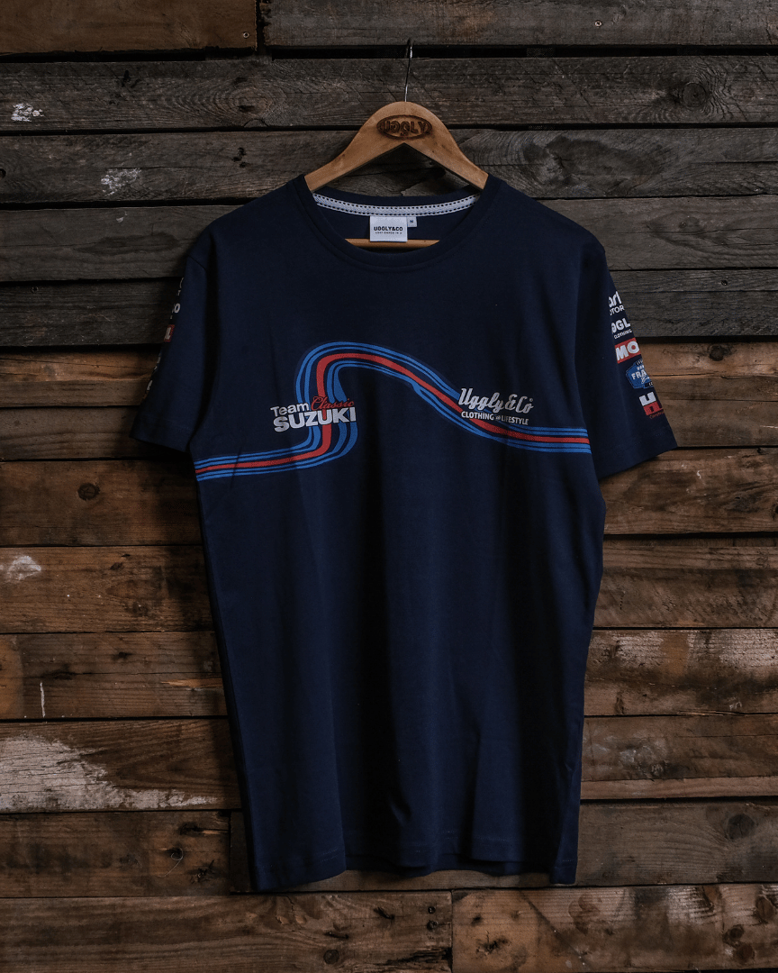 Front view of a navy Team Classic Suzuki blue t-shirt with Uggly&Co branding on a wooden background