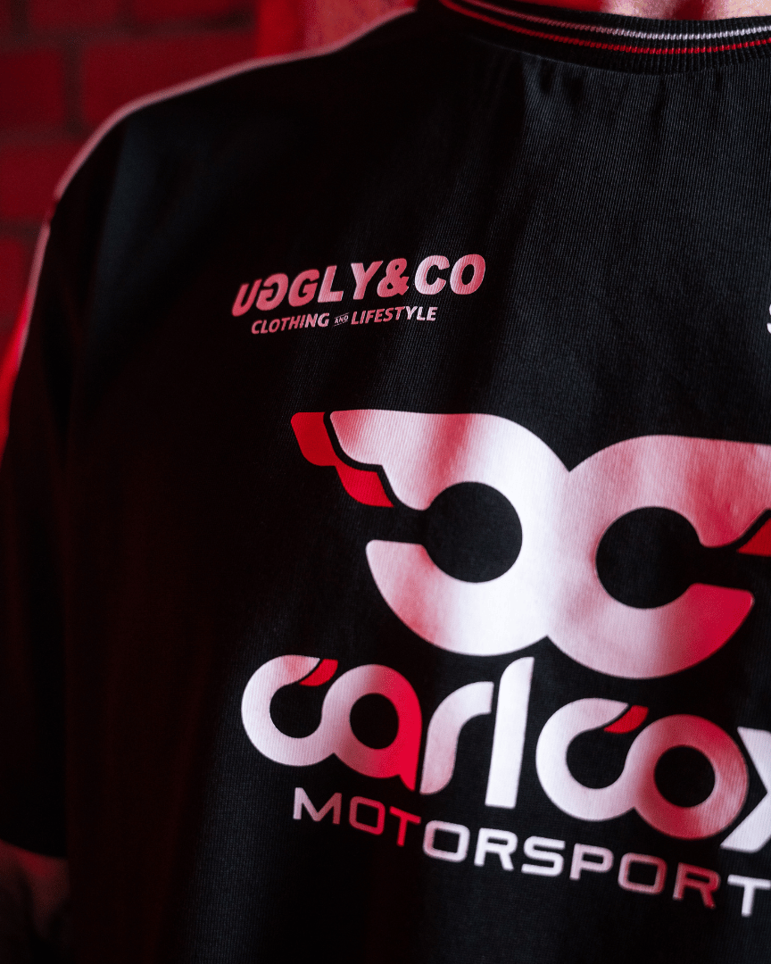 Close up of the front logo on a Carl Cox motorsport and Team Classic Suzuki black and red t-shirt