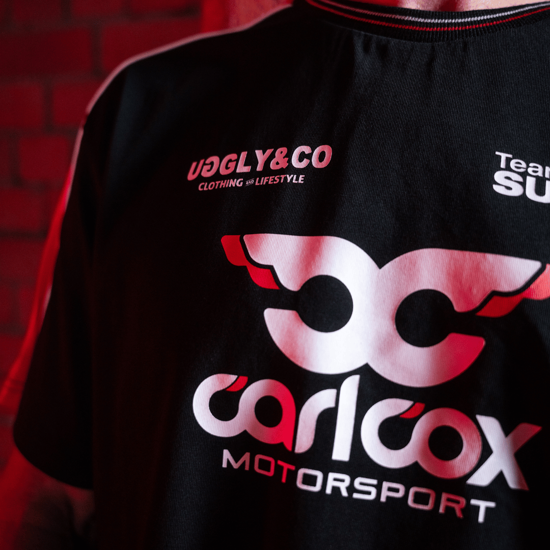 Close up of the front logo on a Carl Cox motorsport and Team Classic Suzuki black and red t-shirt