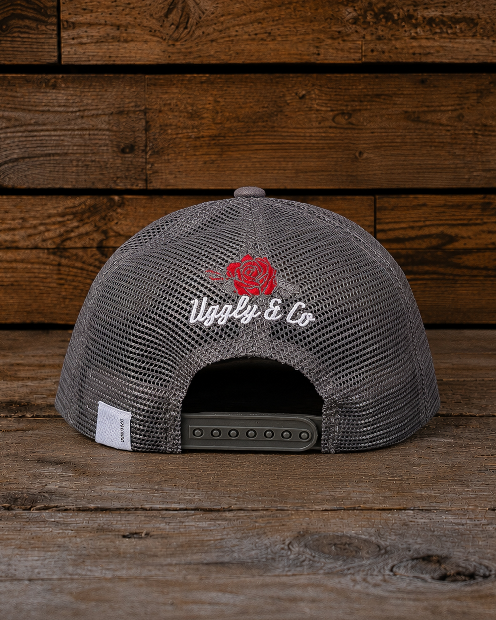 Back view of the Rose Diamond Cap showing the grey mesh panels, snapback closure, embroidered rose detail and small Uggly&Co rear tag.
