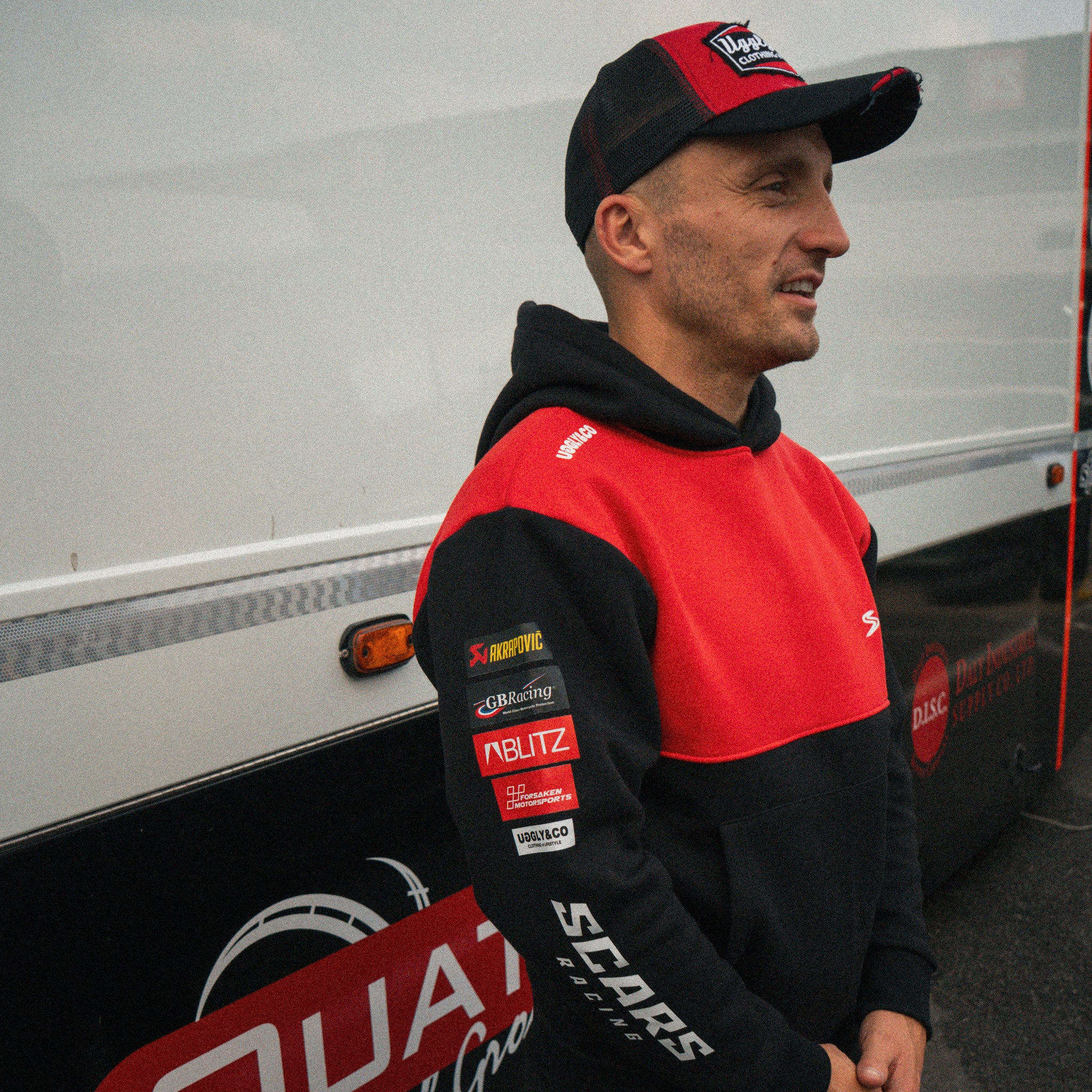 Luke Stapleford wearing a black Scars Racing hoodie in the paddock