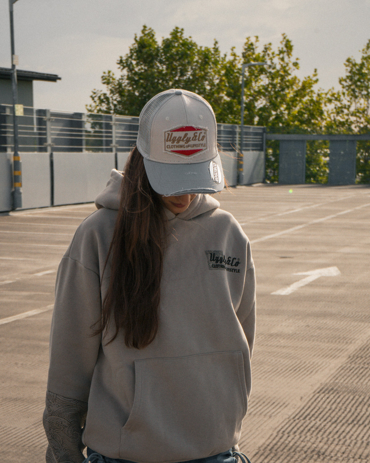 Female model wearing the Silver & Grey Diamond Trucker Hat
