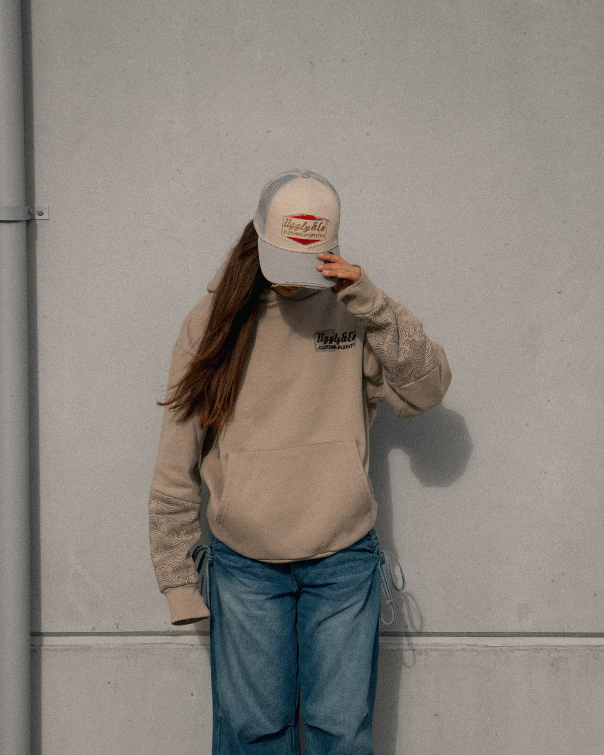 Women’s lifestyle photo featuring the Silver & Grey Diamond Trucker Hat