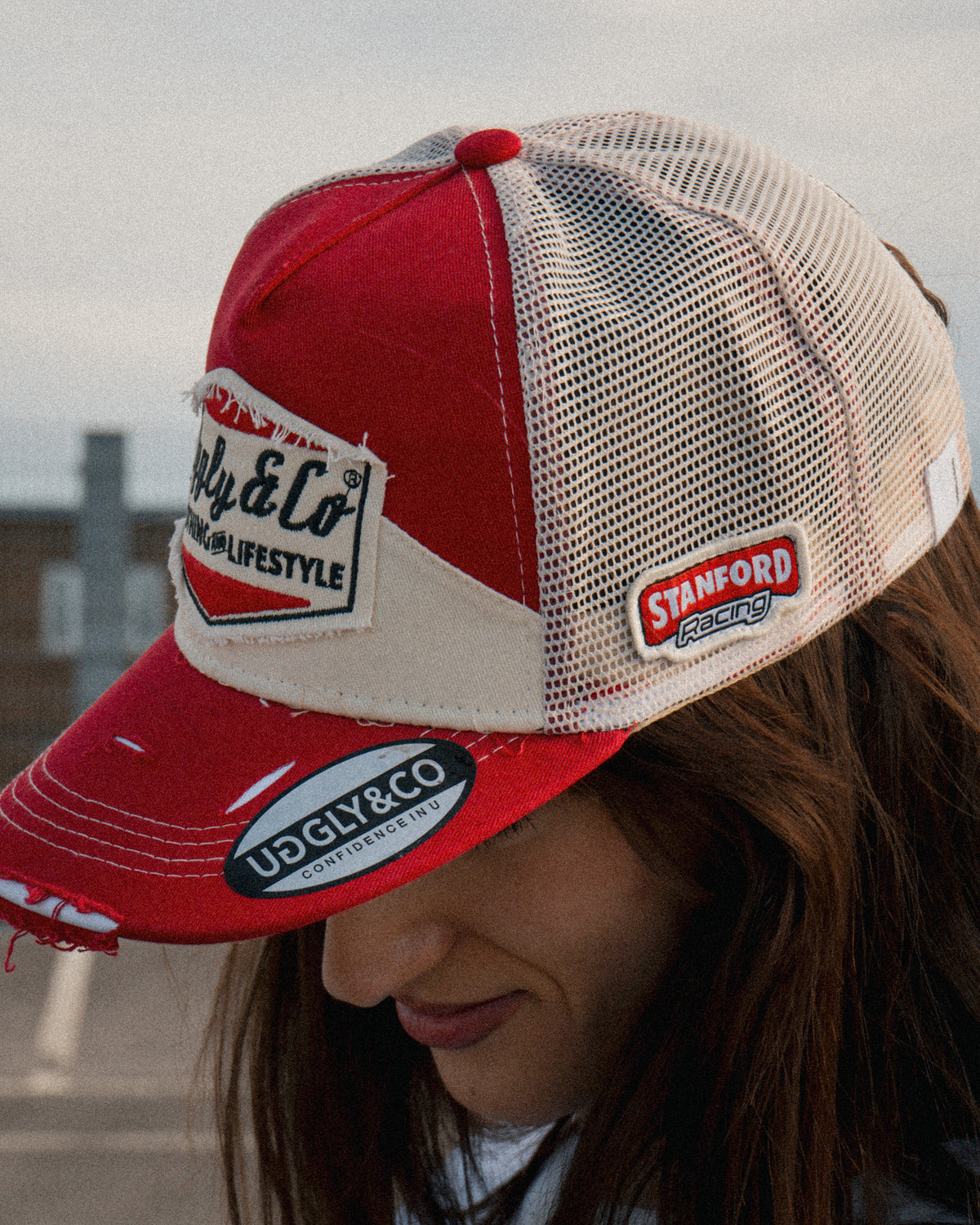 Lifestyle photo of a female model wearing the Smokin’ Diamond Trucker Hat. Marlboro inspired cap.