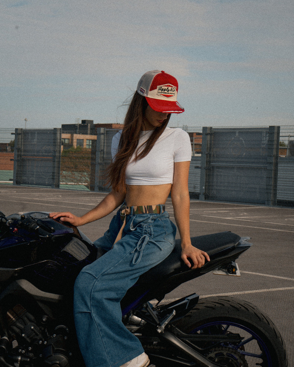 Female model styling the Smokin’ Red Label Diamond Marlboro inspired Trucker Hat