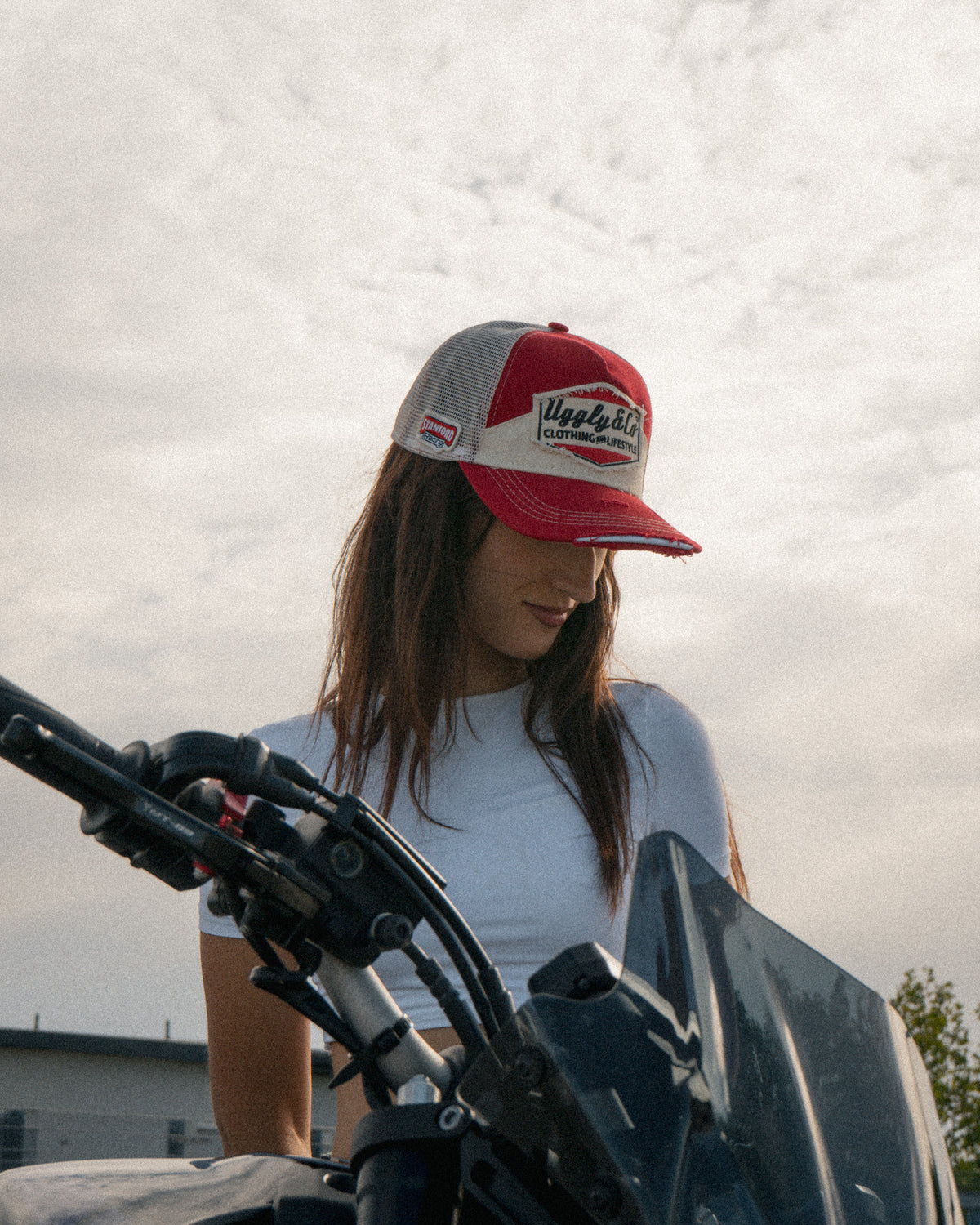 Lifestyle image featuring the Smokin’ Red Label Diamond Trucker Hat. Marlboro cap.
