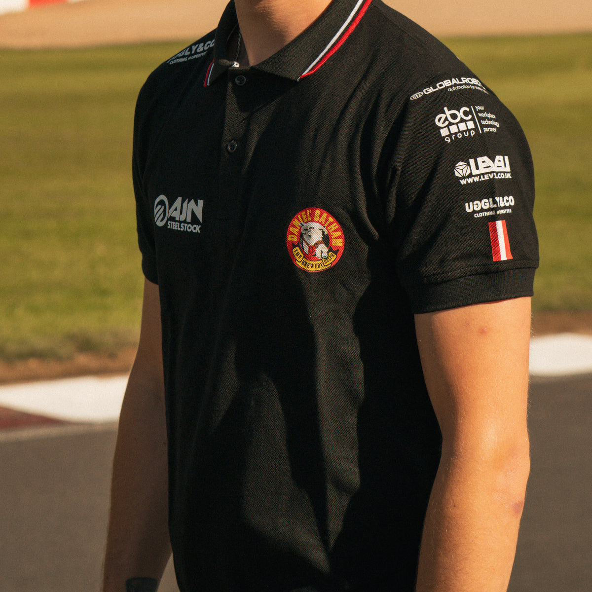 Close-up of the chest logos on the Bathams Racing x AJN Steelstock Road Racing Polo worn by Storm Stacey