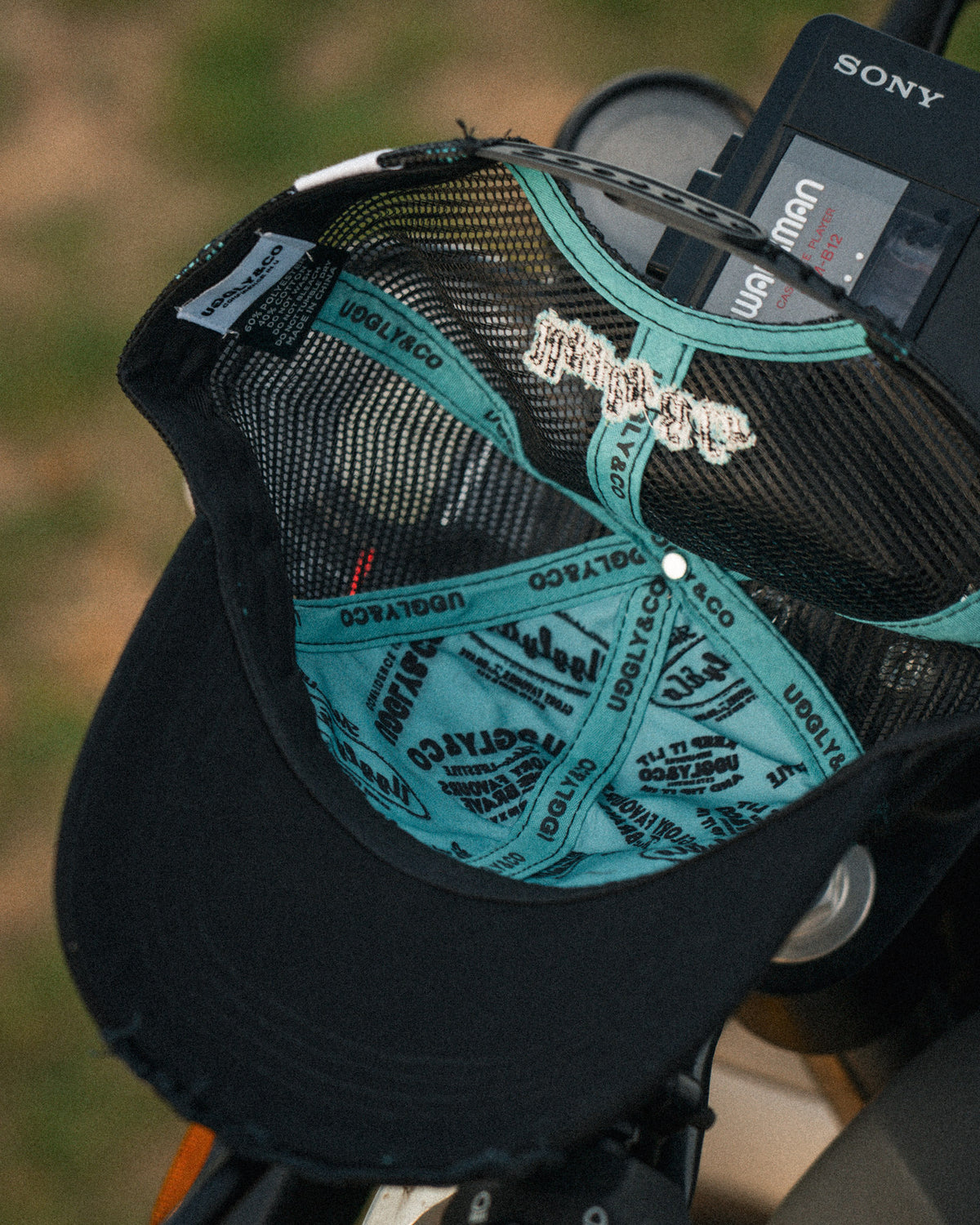 inner lining of black and turquoise trucker hat