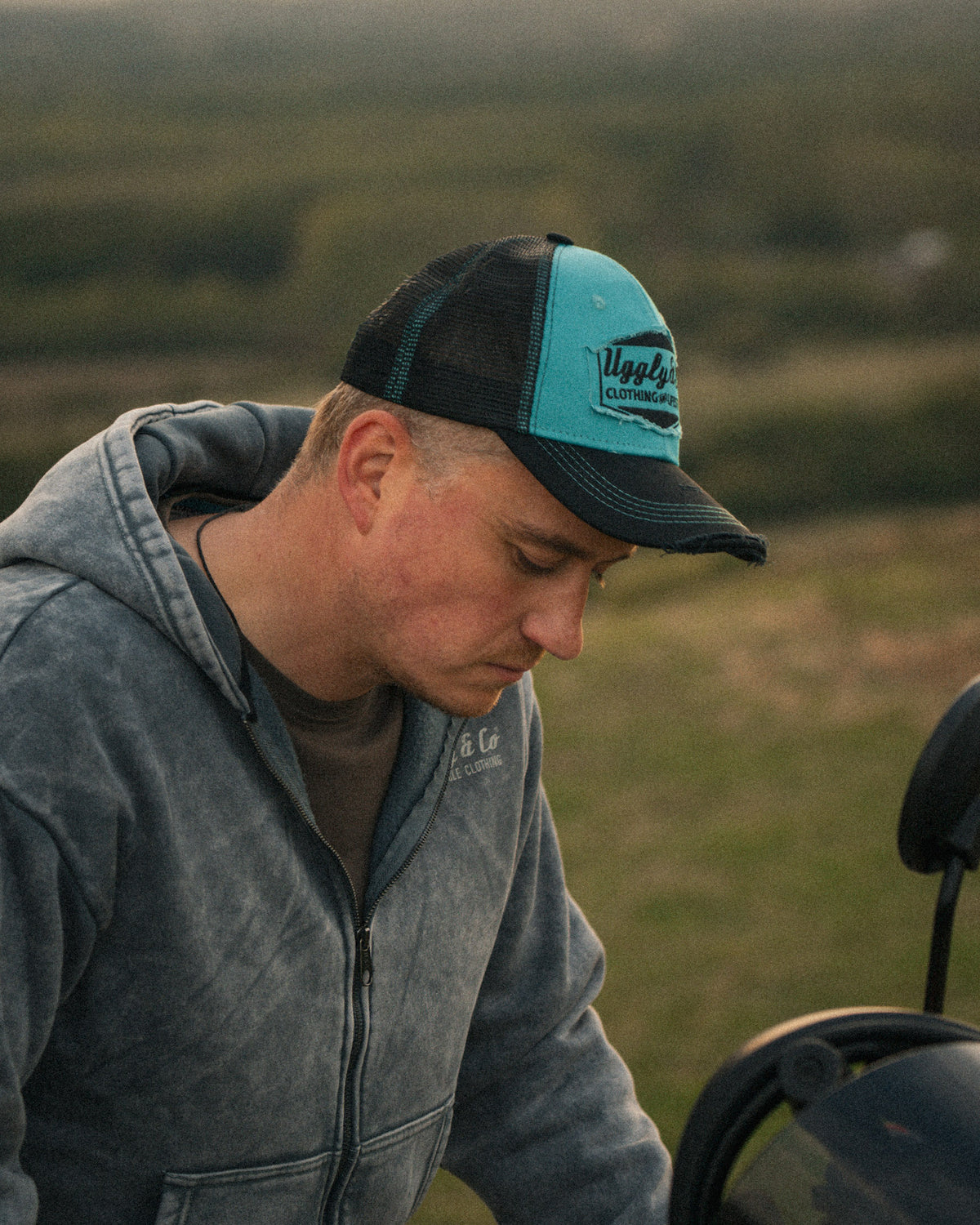 Turquoise & Black Diamond Cap worn in a lifestyle setting with a Scram 411