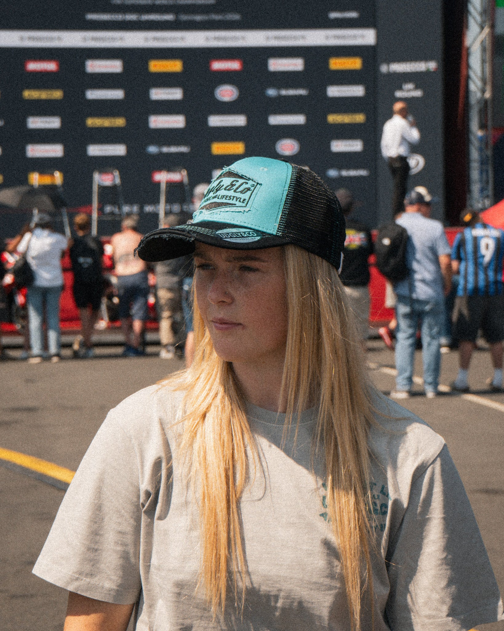 Chloe Jones wearing the Uggly&Co Turquoise and Black Diamond Cap at the racetrack
