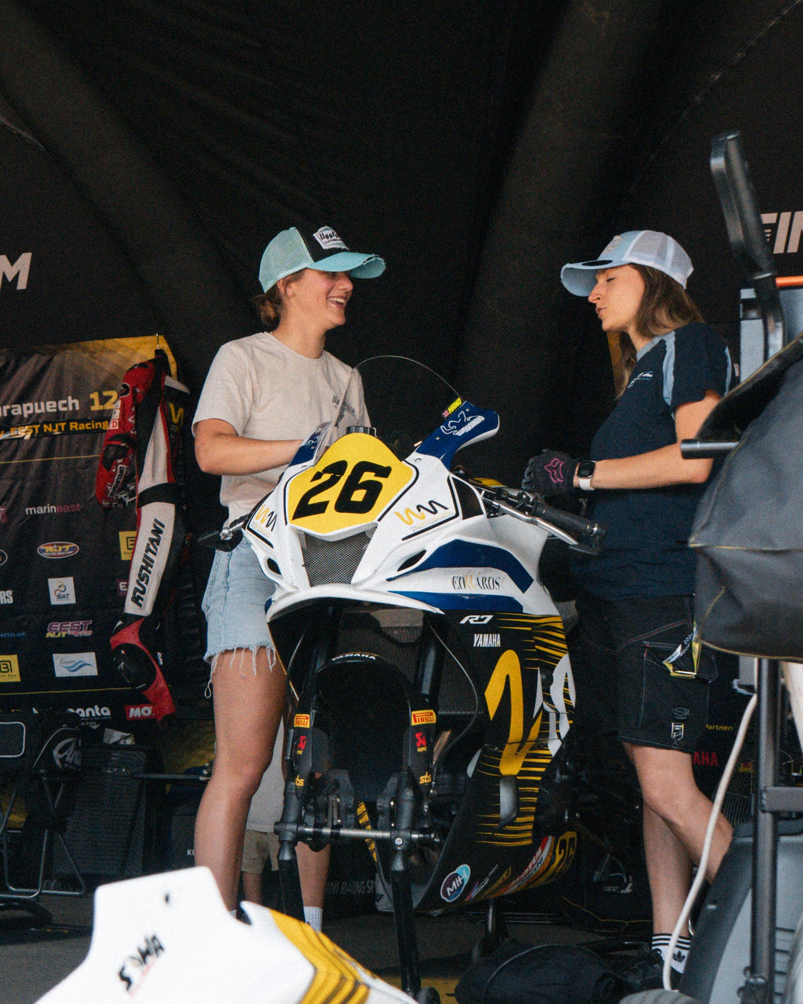 Katie hand with female mechanic wearing vintage trucker hat