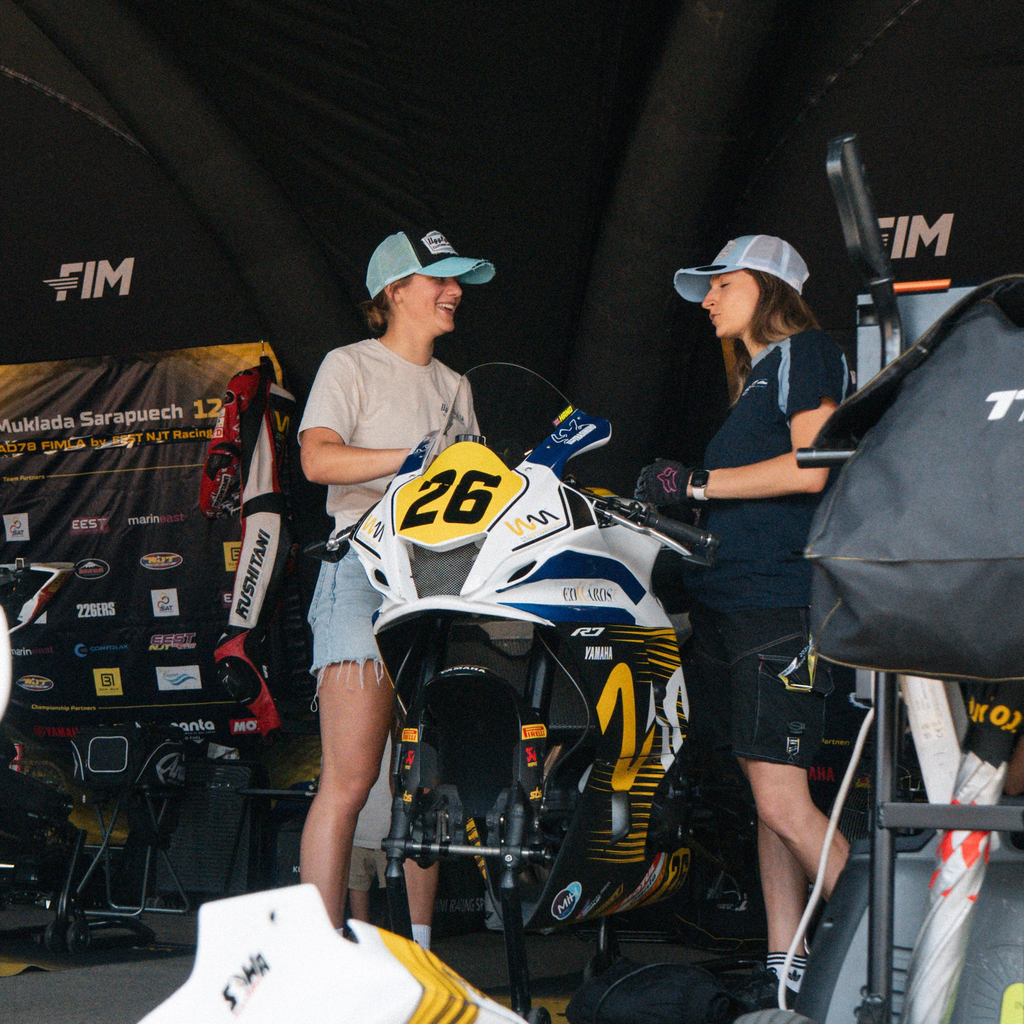 Katie hand with female mechanic wearing vintage trucker hat