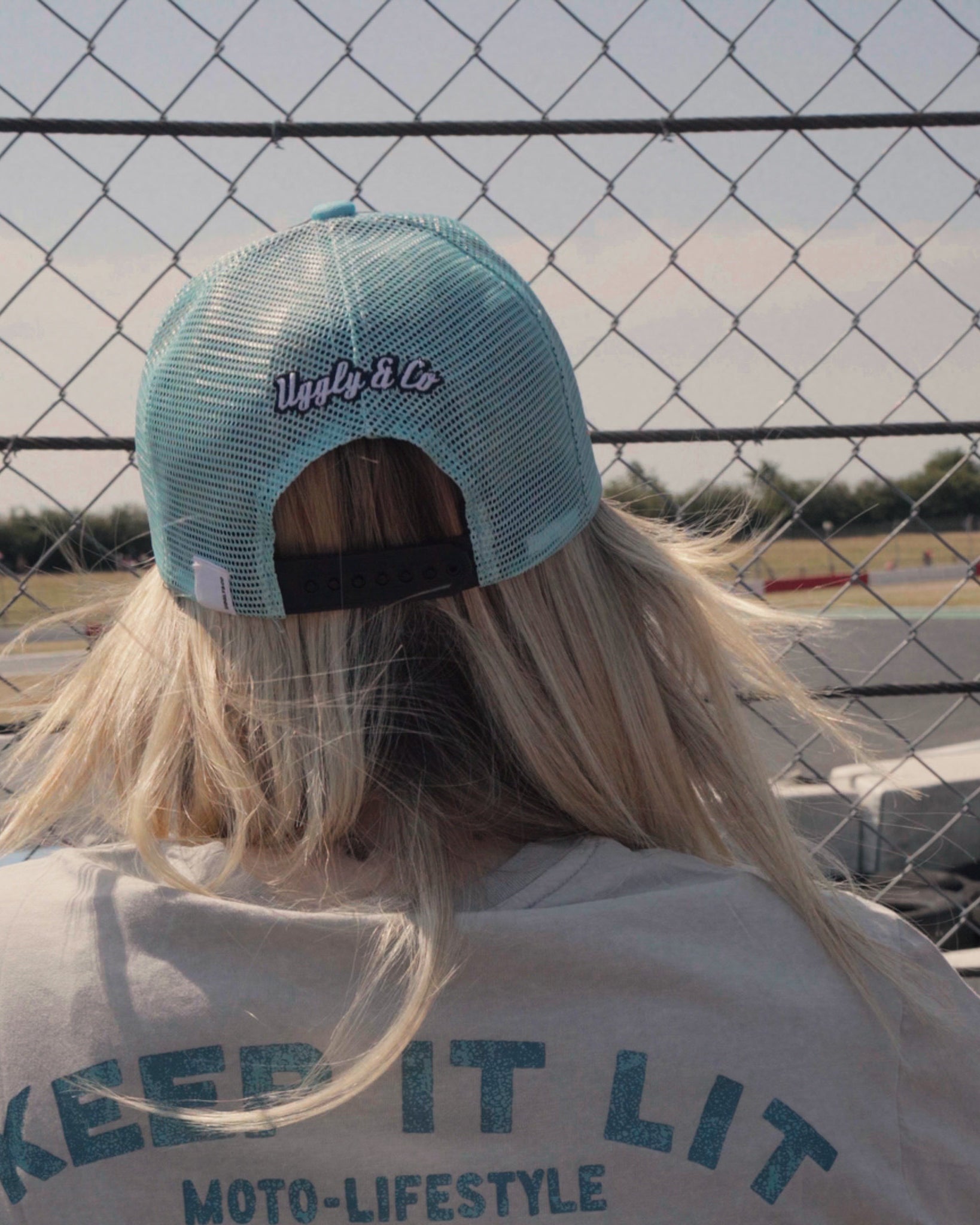 close up shot of Chloe jones wearing turquoise trucker hat