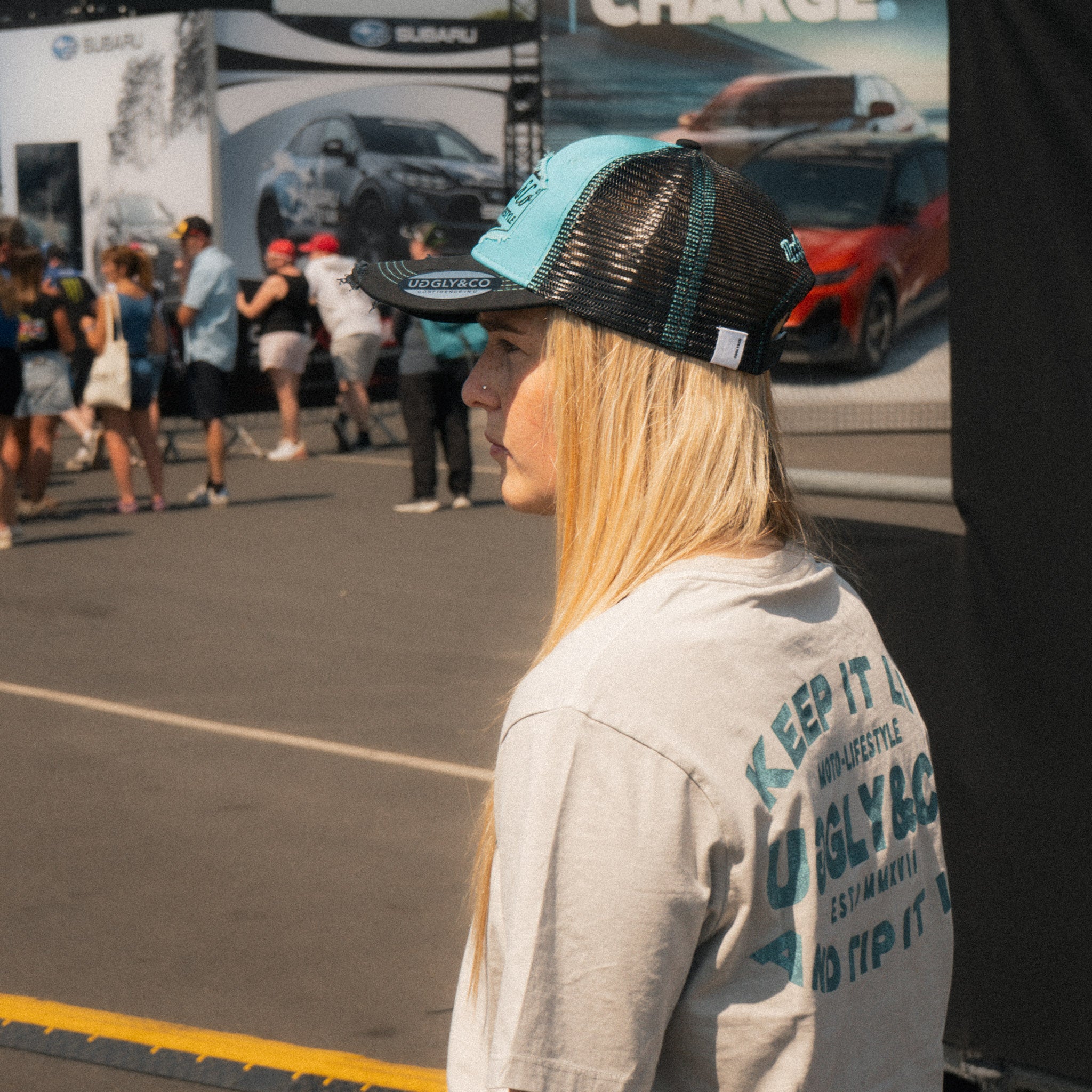 Chloe Jones wearing the Turquoise and Black Diamond Cap with a casual motorsport look