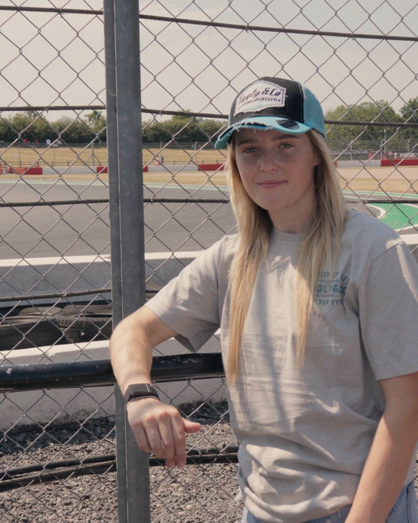 Chloe jones wearing the turquoise and black Retro Diamond trucker cap