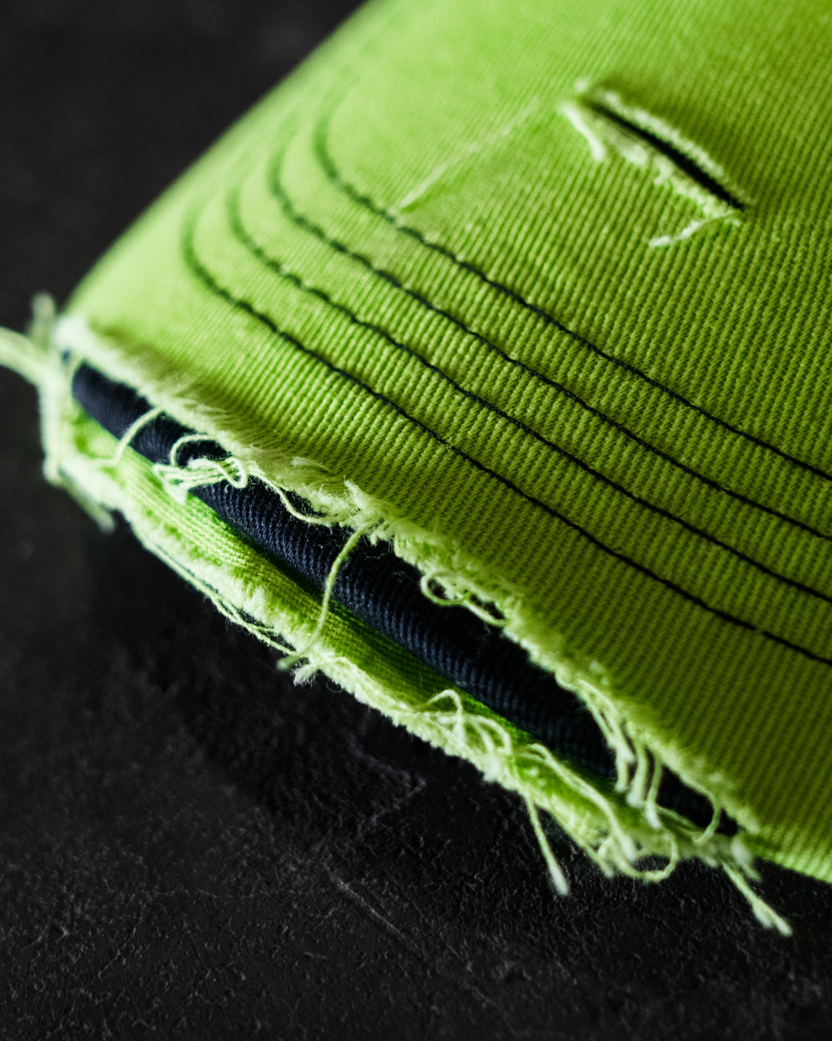 close up photo showing the peak of Kyle Ryde fluro limited edition trucker hat