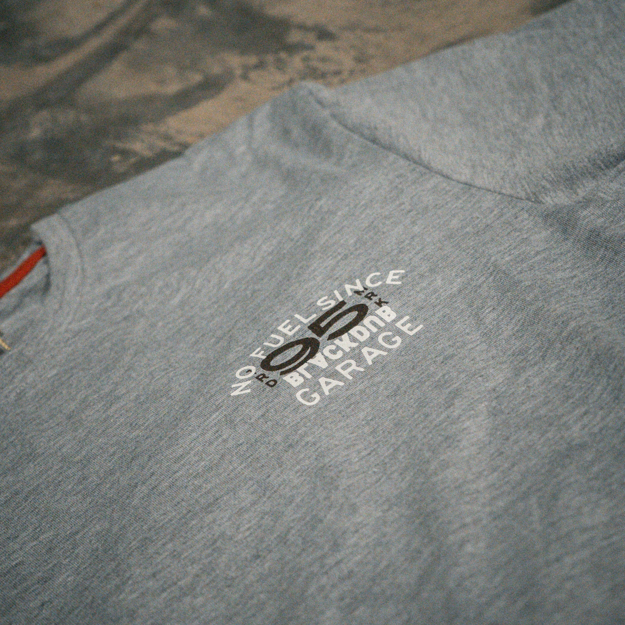 Close up of the No Fuel Since ’95 graphics on the grey Uggly & Co T-shirts.