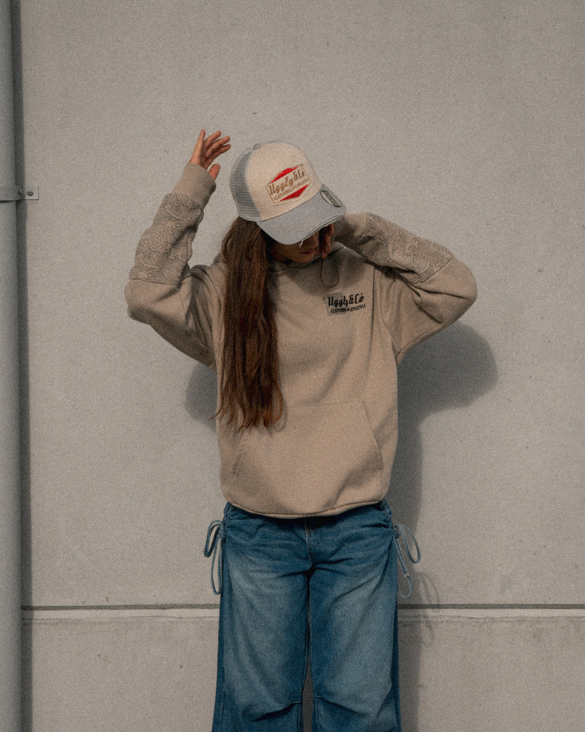 Female model wearing the Uggly & Co Silver & Grey Diamond Trucker Hat