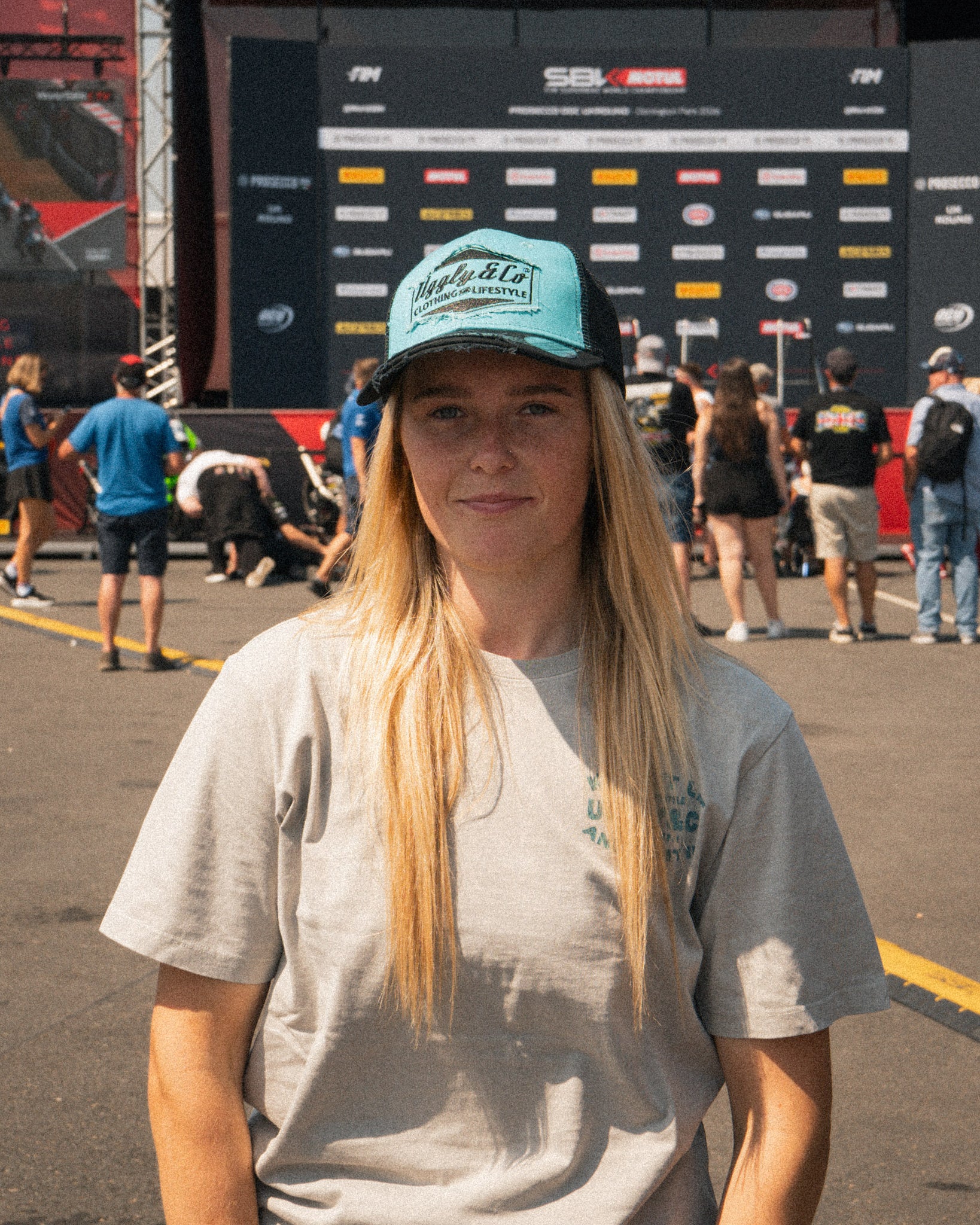 Chloe Jones in the Uggly&Co Turquoise and Black Diamond Cap during a race weekend