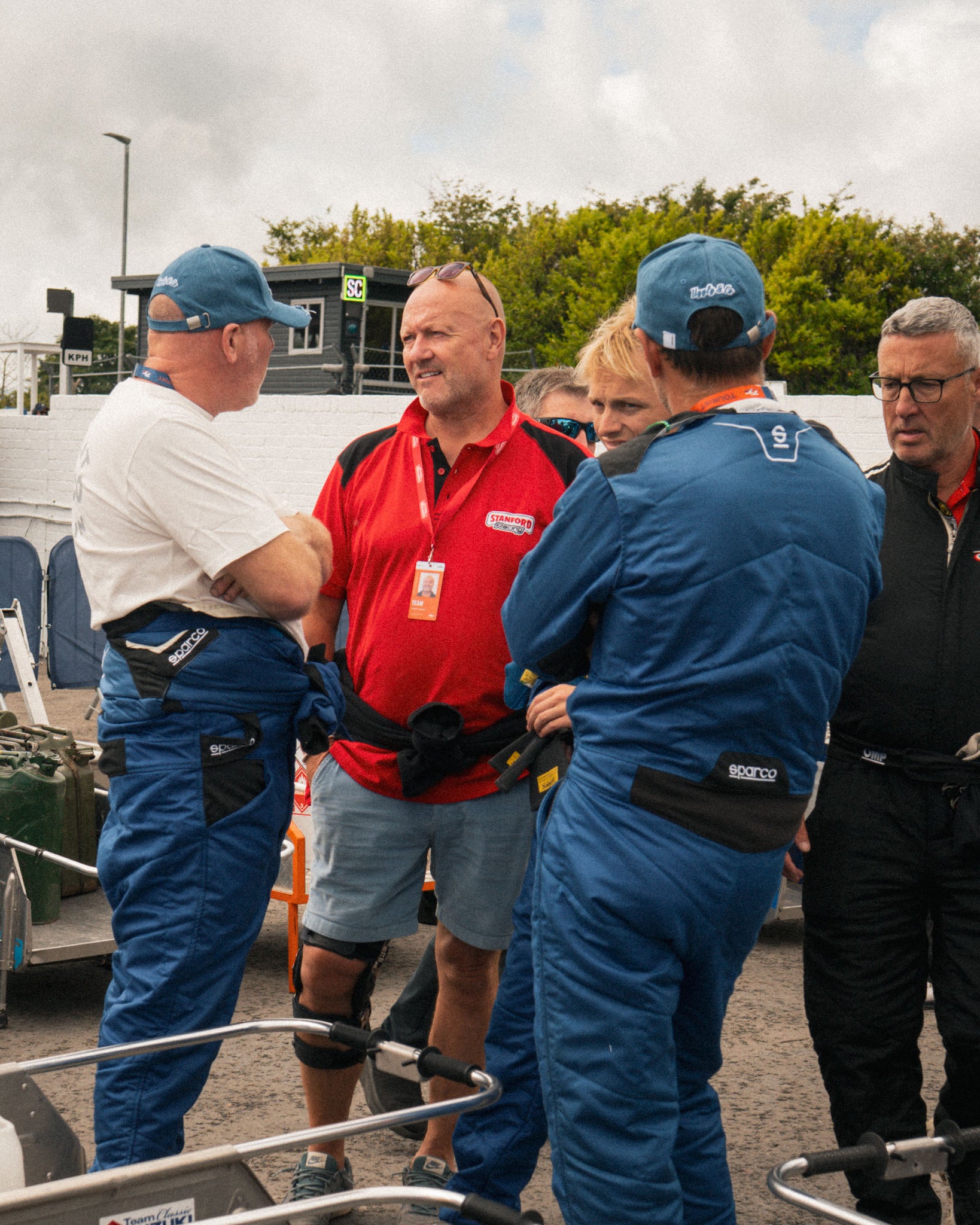 Motorsport mechanics wearing a denim Diamond baseball cap during race day