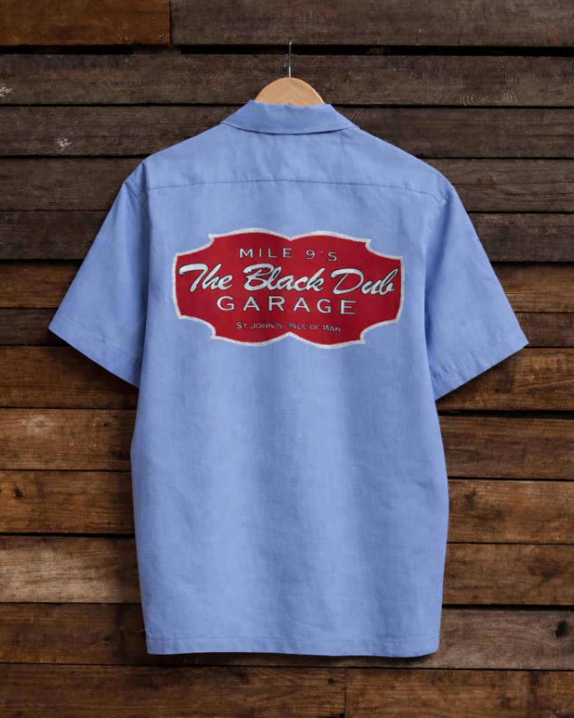 Blue work shirt with a red logo on a wooden background