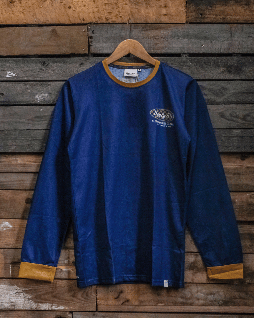 Blue MX shirt with an Uggly&Co logo on a wooden background