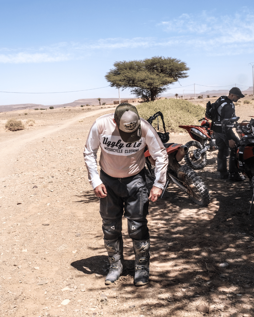 MX Rider on the trail wearing a motocross jersey with 'Uggly & Co Motorcycle Clothing' logo