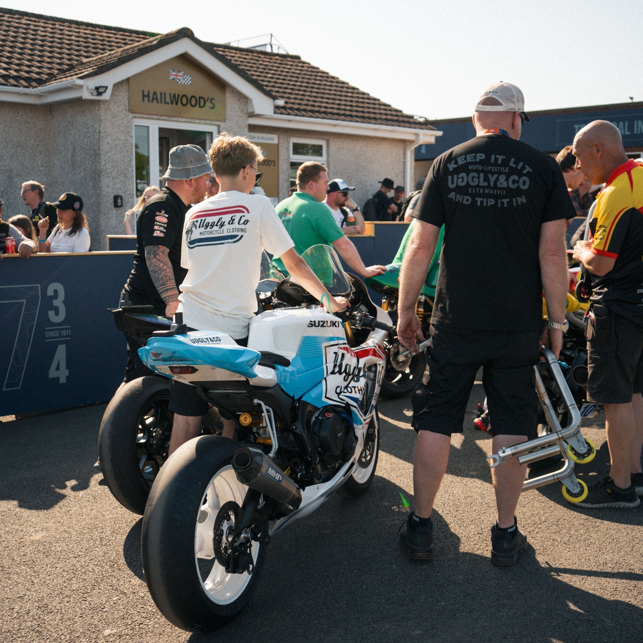 race mechanics walking bike up to inspection at Isle of Man tt