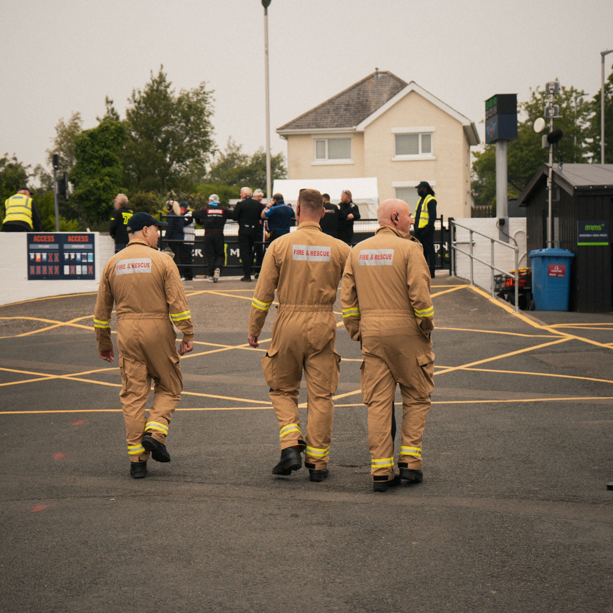 fire men in pit lane at race track