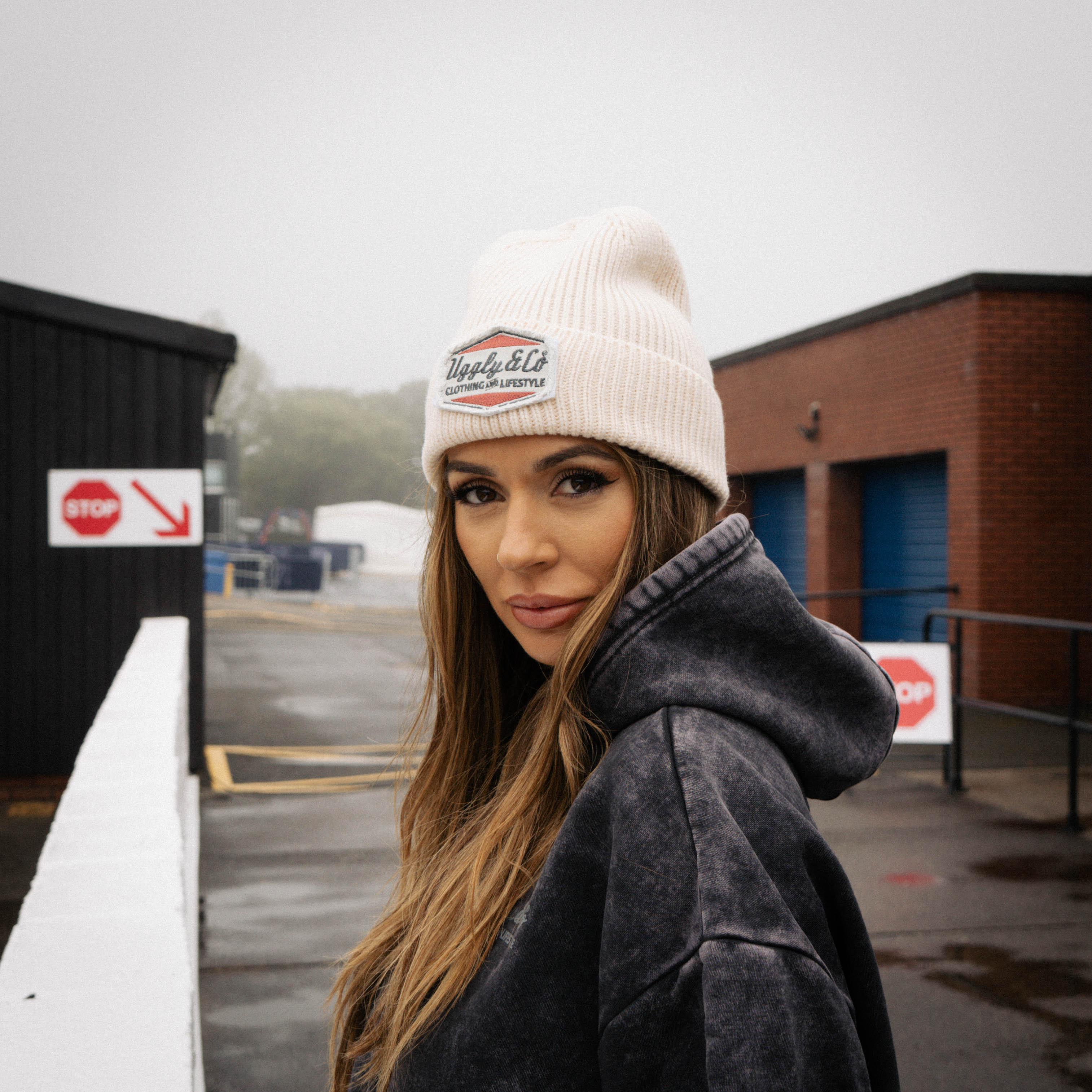 girl pictured in beige beanie at motorsport race