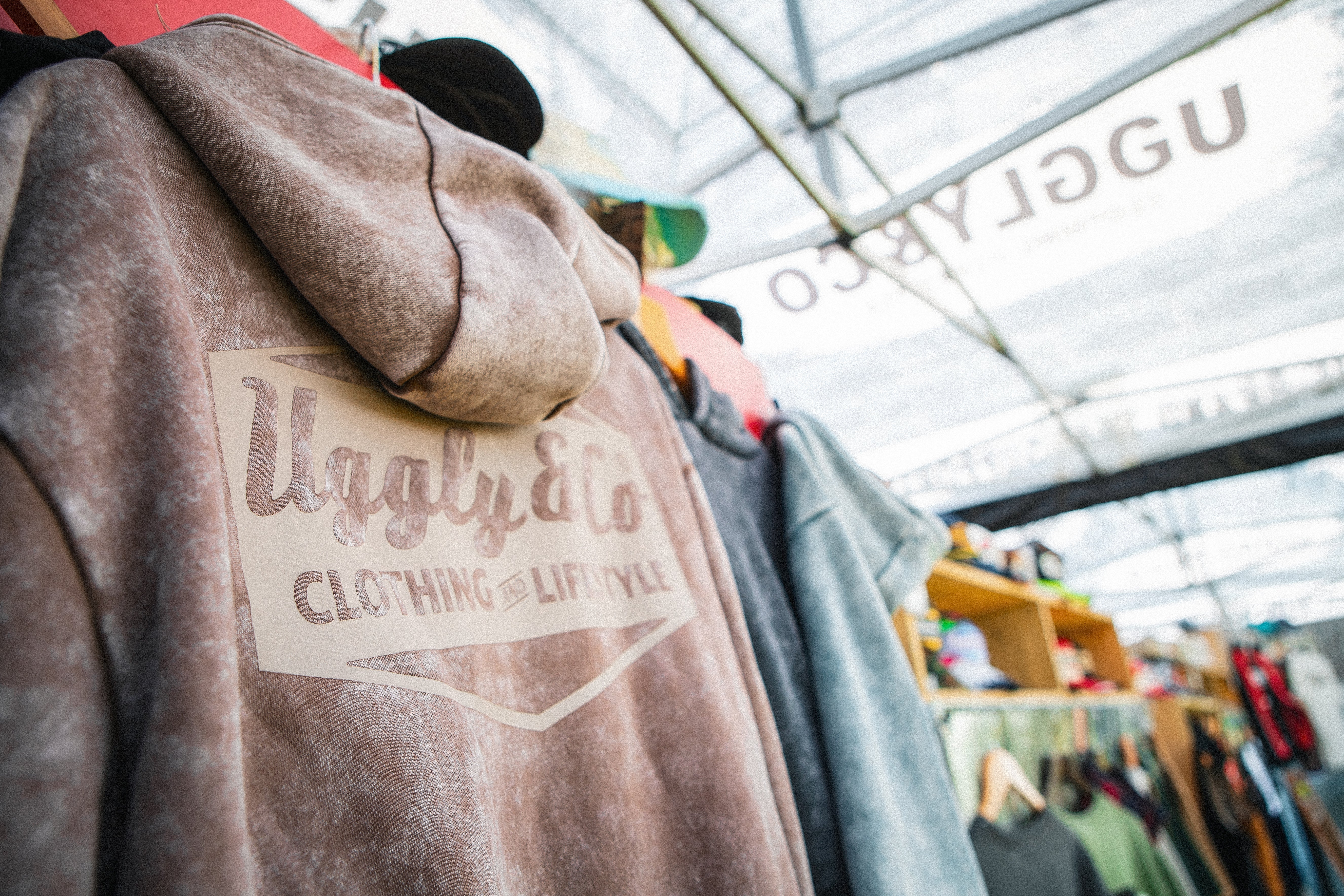 An image showing a range of Uggly&Co hoodies hung up on a display.