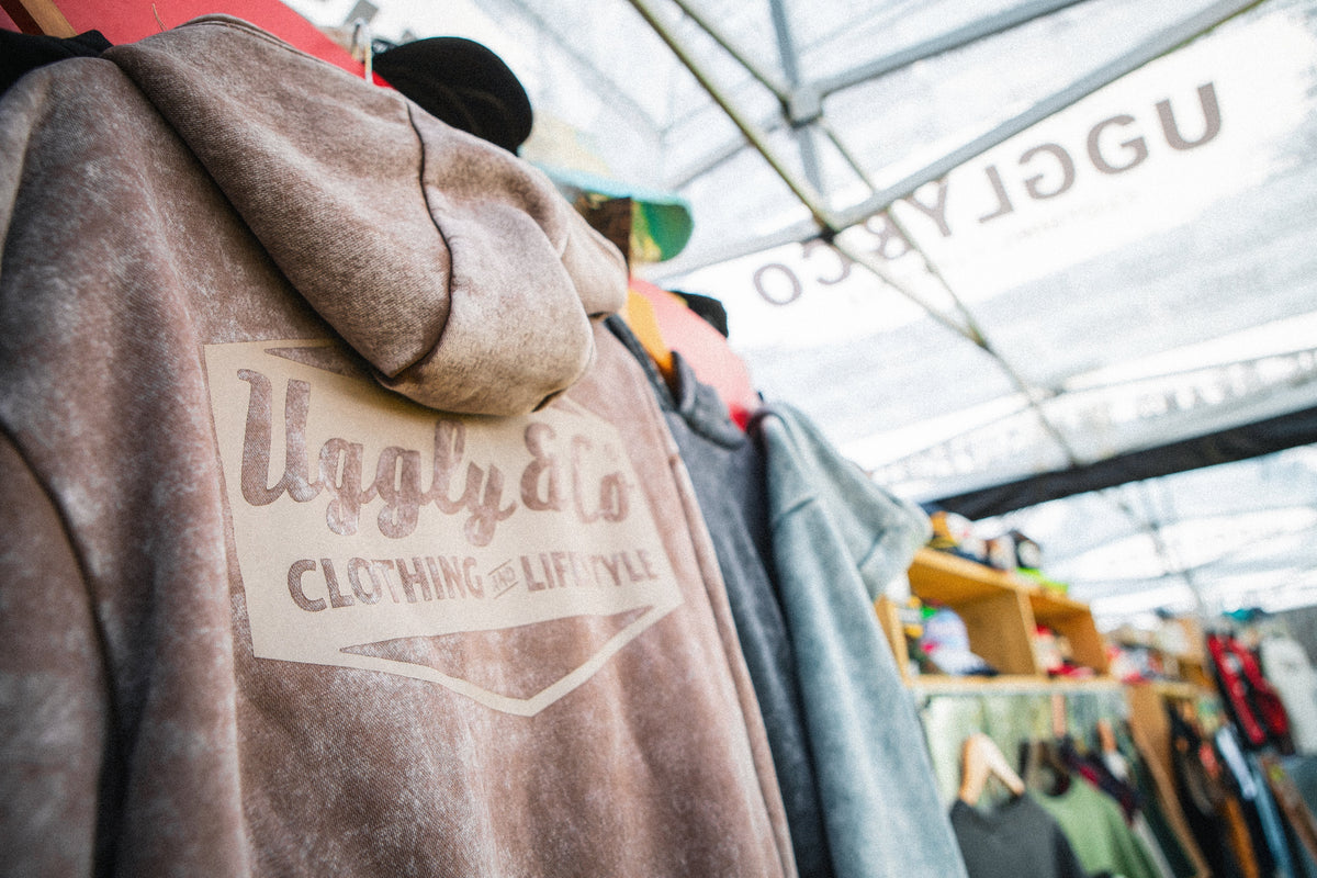 An image showing a range of Uggly&Co hoodies hung up on a display.
