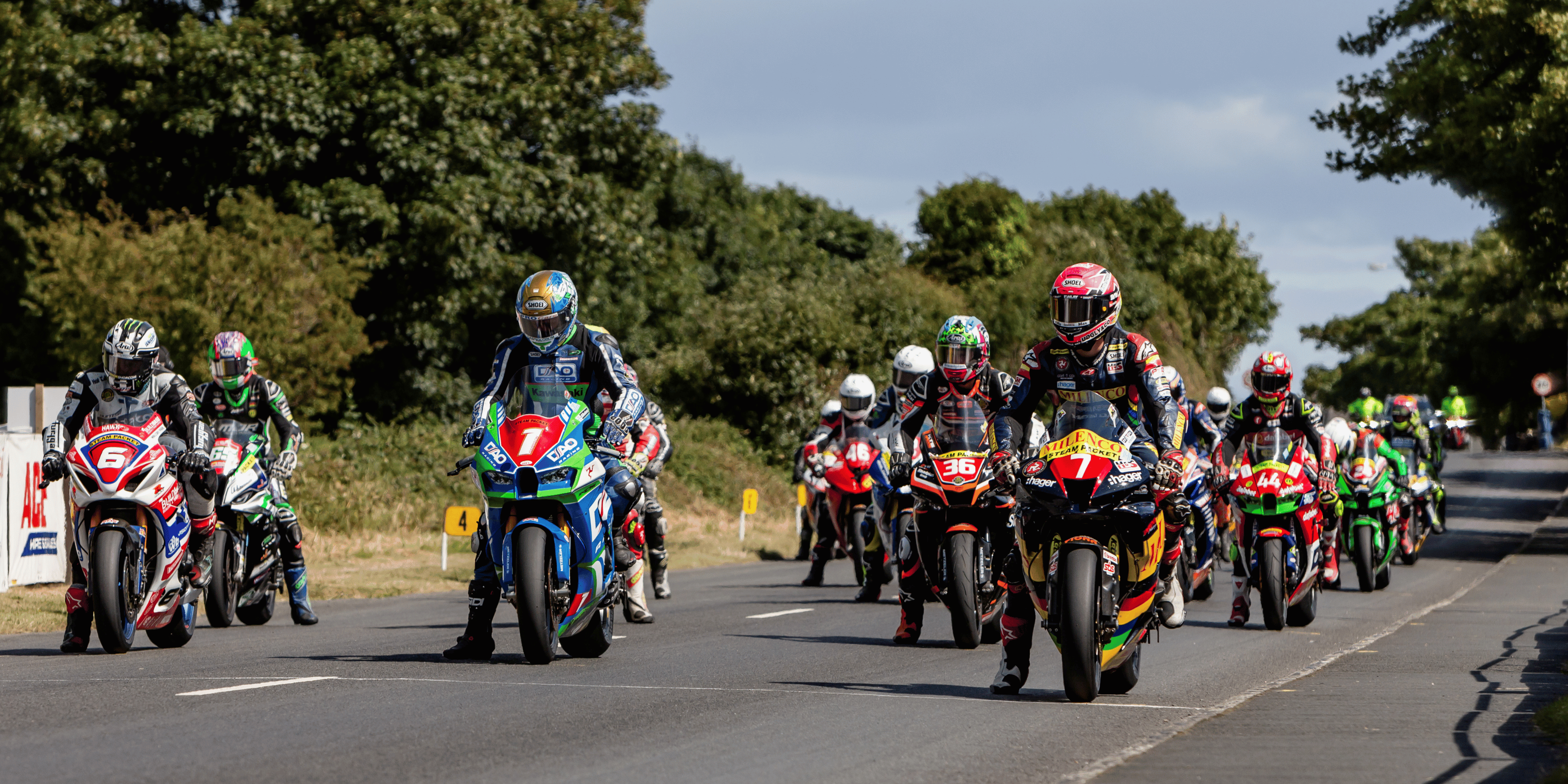 Southern 100 motorcycle racers lining up on the racing grid