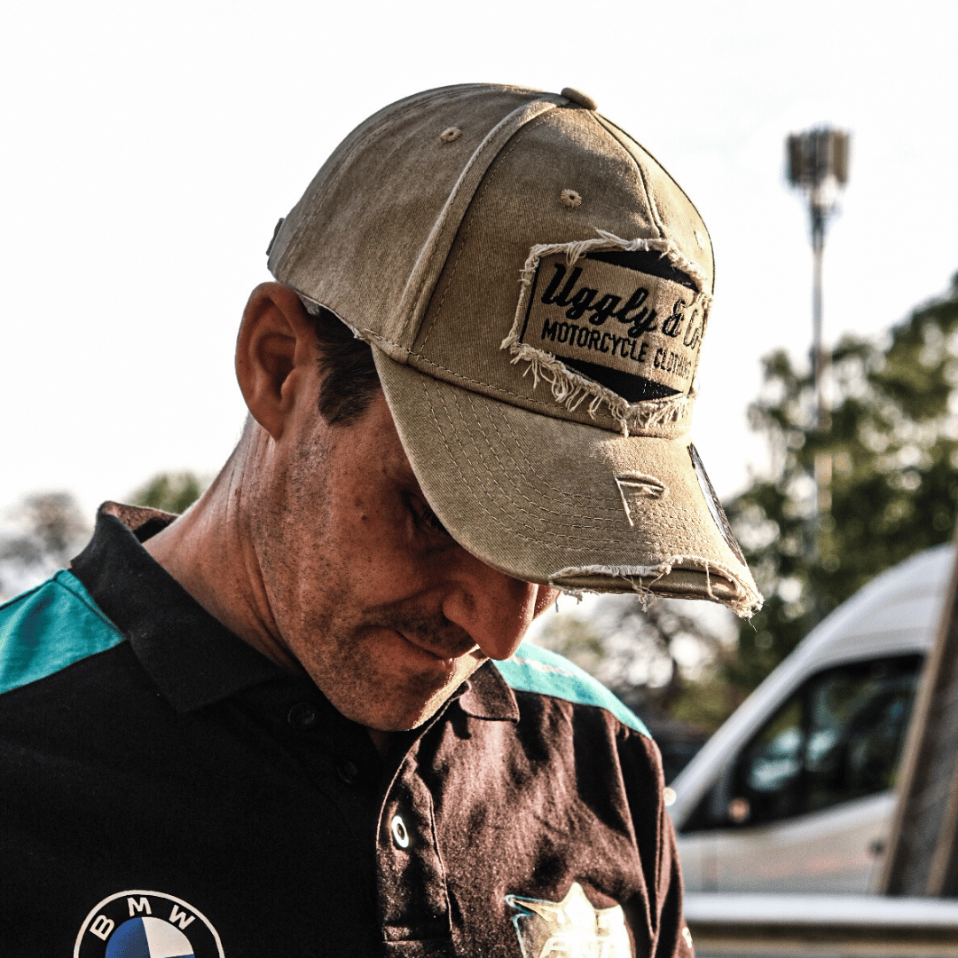 Model looking down while wearing a vintage green Uggly&Co baseball cap