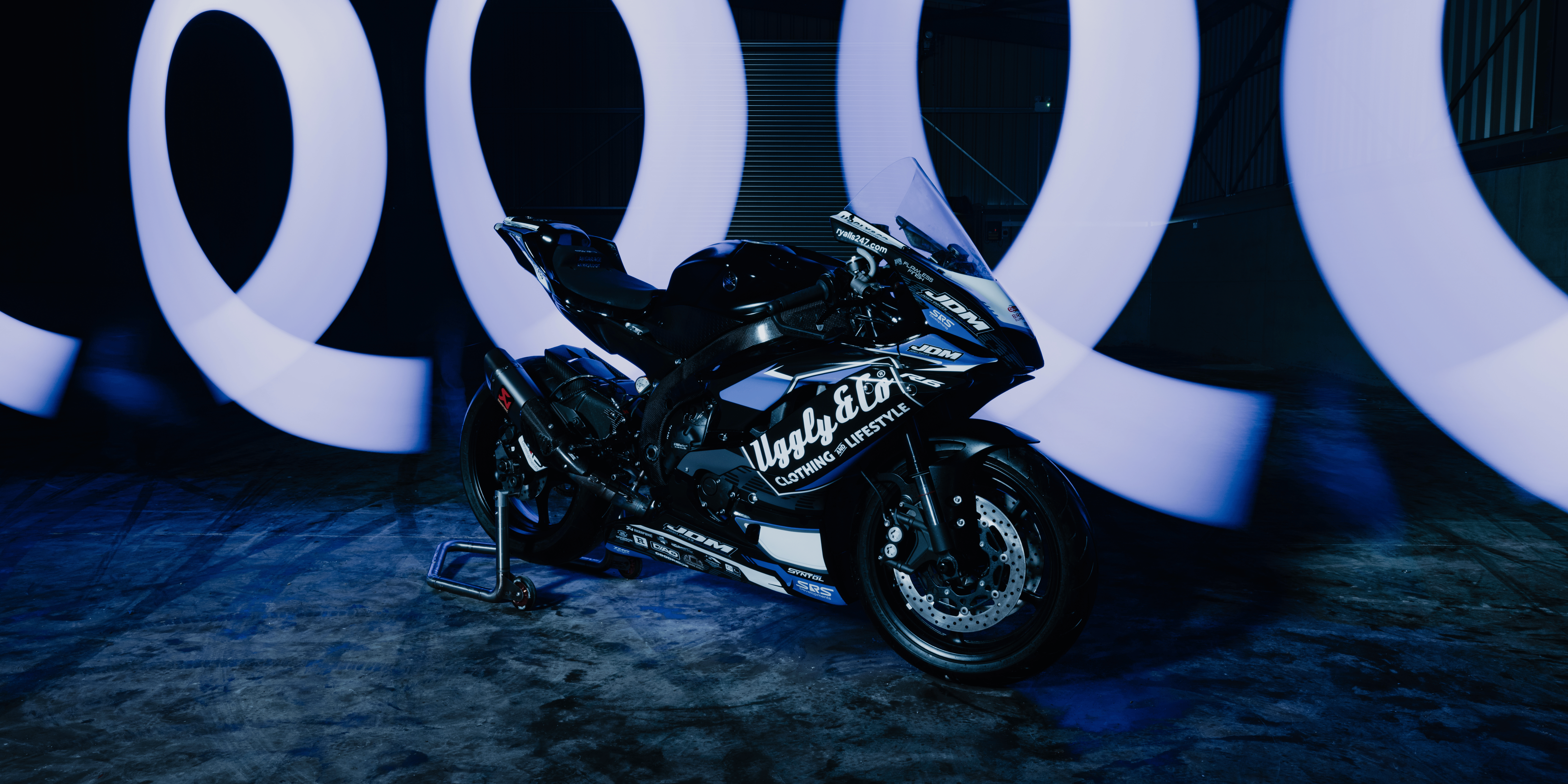 Uggly&Co branded motorcycle with a blurred background